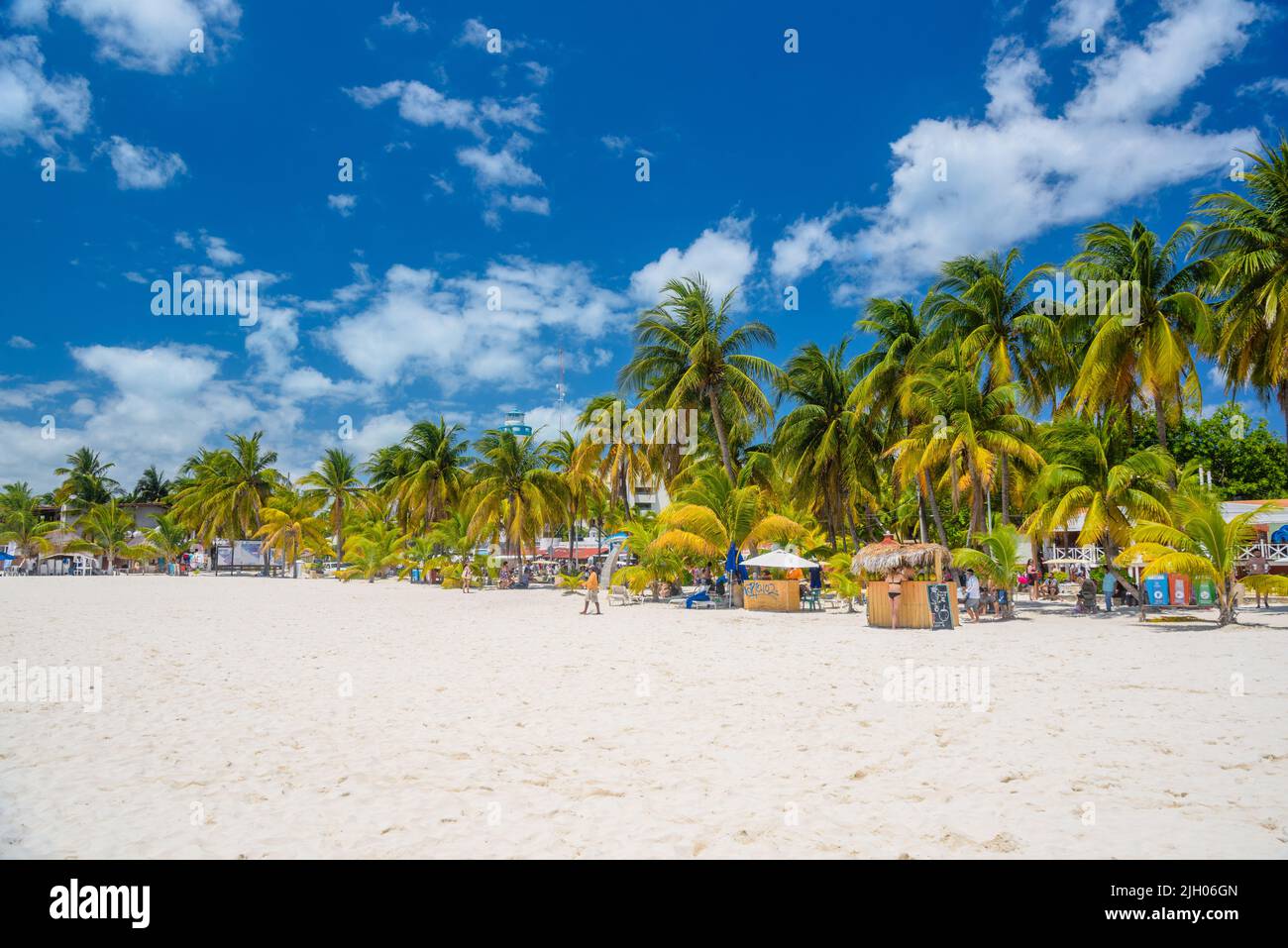 Cocos beach bar on a beach with white sand and palms on a sunny day, Isla Mujeres island, Caribbean Sea, Cancun, Yucatan, Mexico. Stock Photo