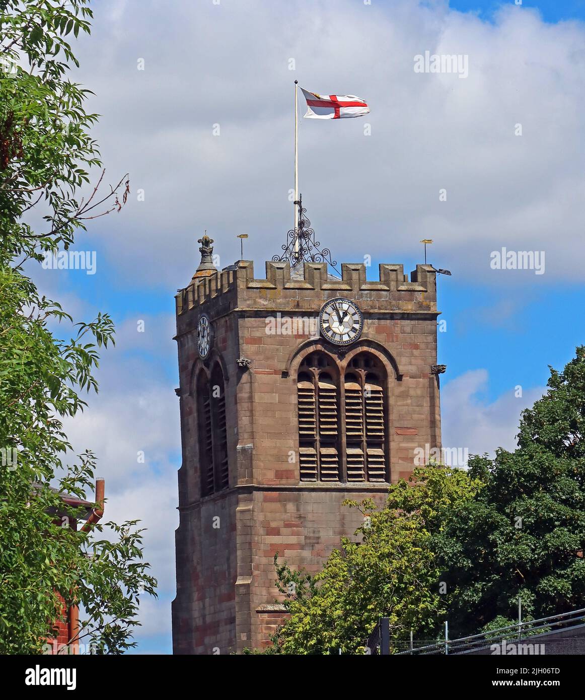 Tower and clock of St Mary The Virgin Church, flying St Georges flag - St Mary's Way, Leigh, Lancs, England, UK,  WN7 5EQ Stock Photo