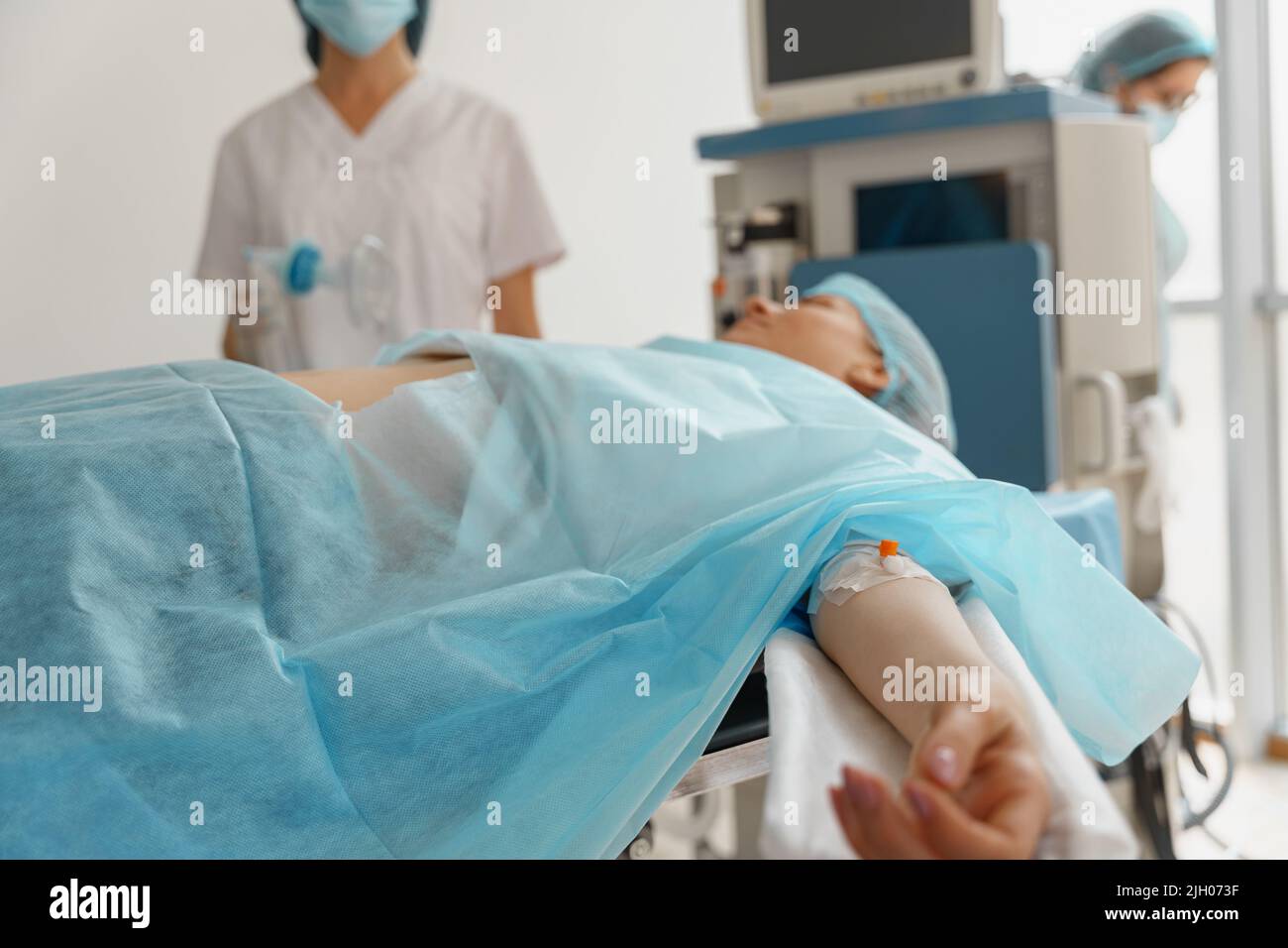 Patient under anesthesia during surgery in operation room Stock Photo