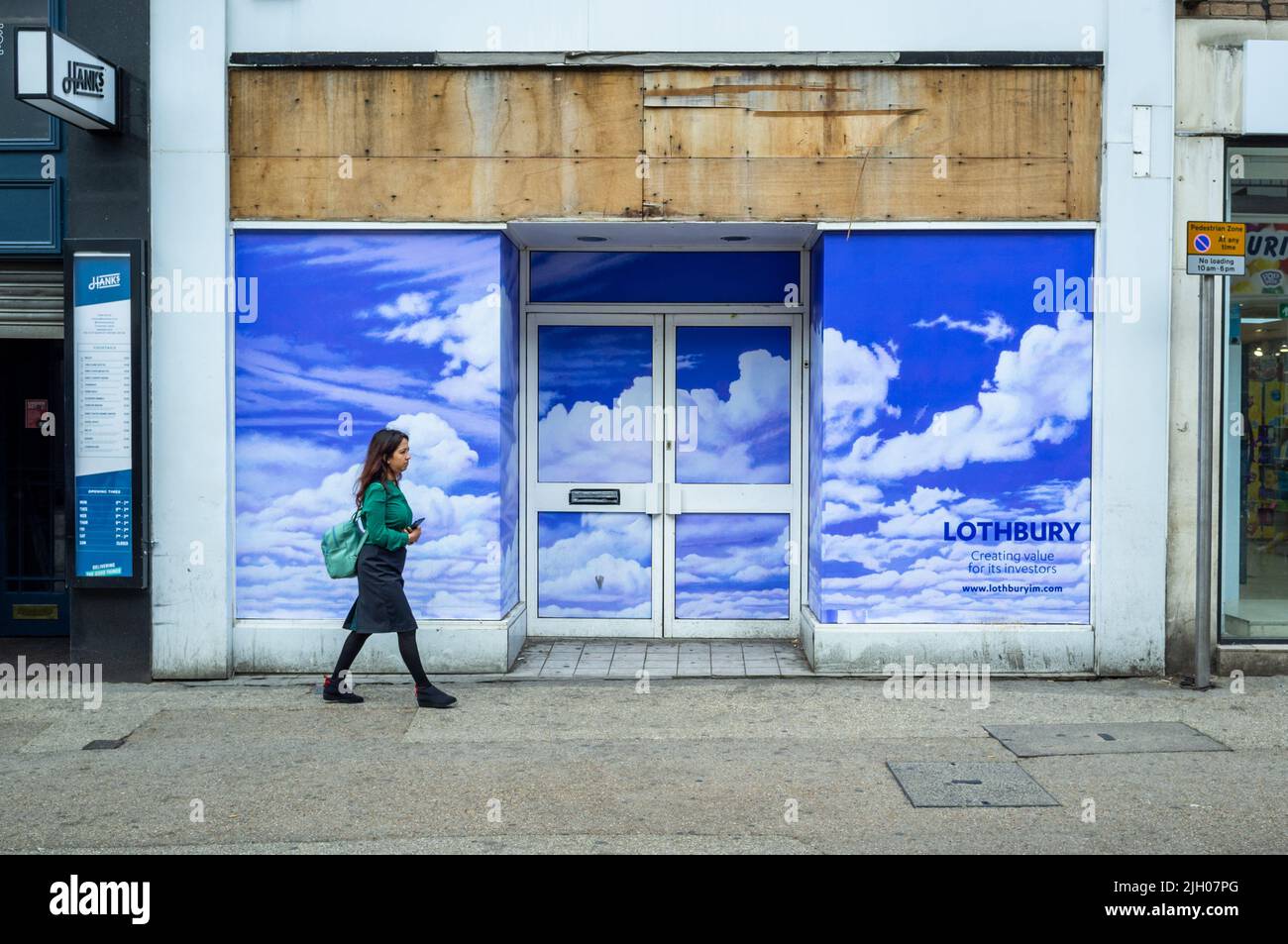 A closed retail shop in Oxford, UK, 2022, with a sunny sky picture in the windows. Stock Photo