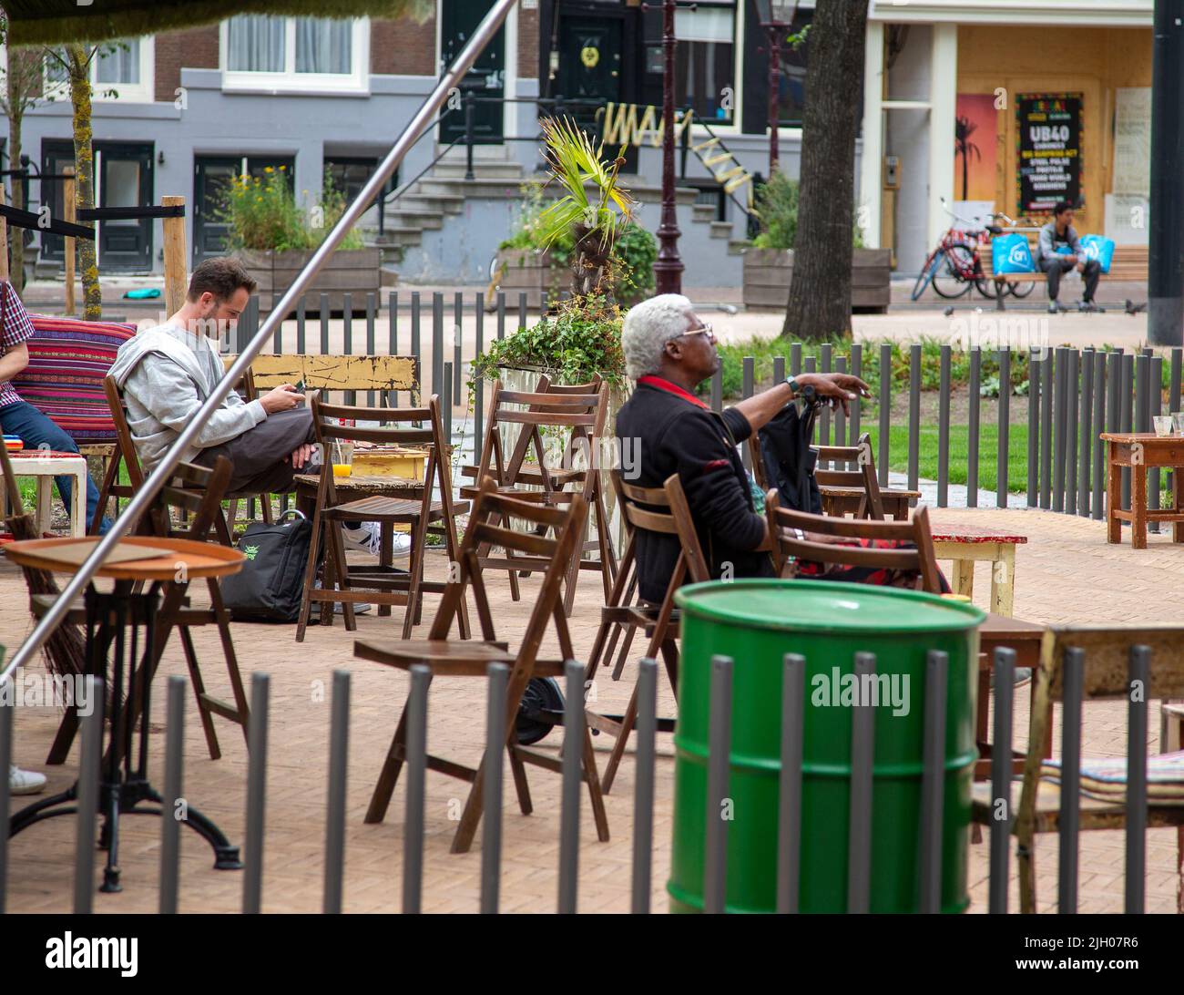 Men sitting at an outdoor cafe in Amsterdam Stock Photo