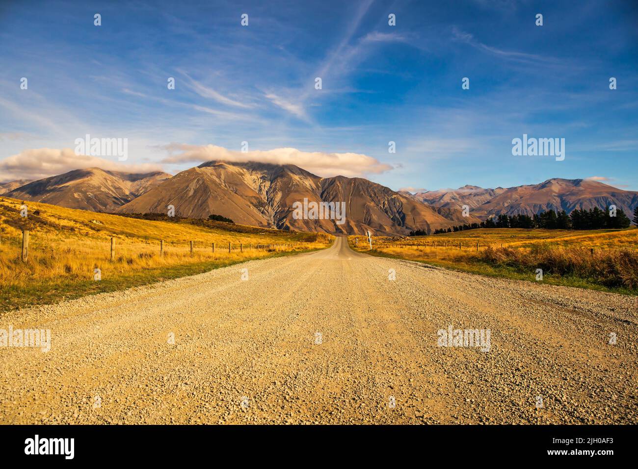 Gravel road in remote rural Coleridge area of the rugged dramatic foothills of the Southern Alps Stock Photo