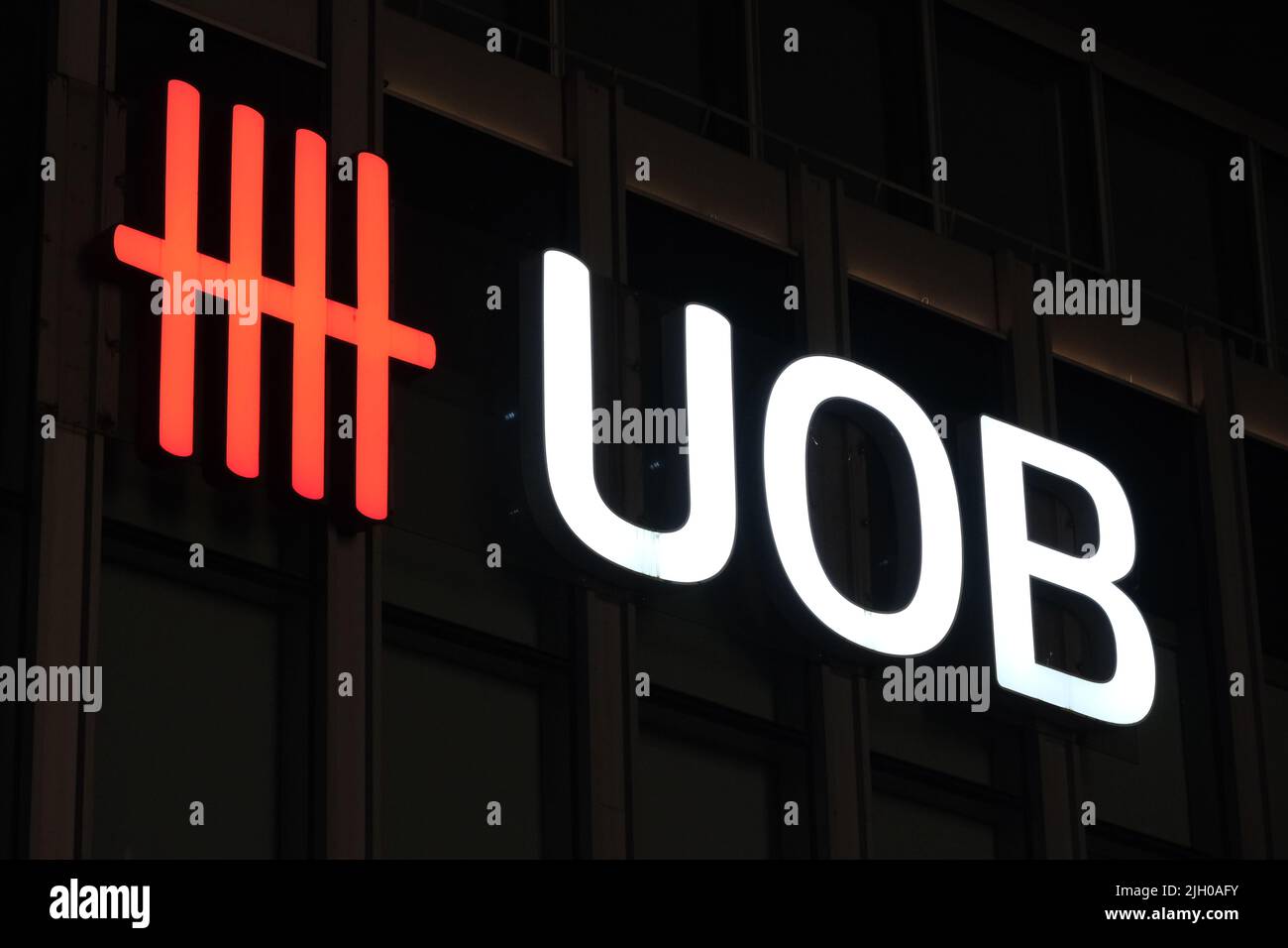 Shanghai,China-Feb.8th 2022: close up UOB bank logo in dark background. United Overseas Bank Limited company sign. Stock Photo