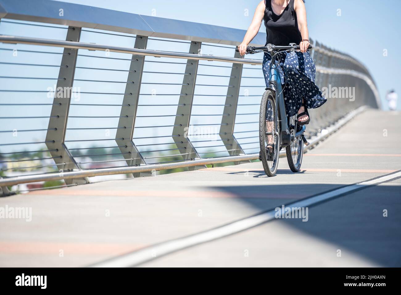 A woman on bicycle and cycling rides are great tools for improving health of the muscles of the hip belt reducing weight and improving female libido i Stock Photo