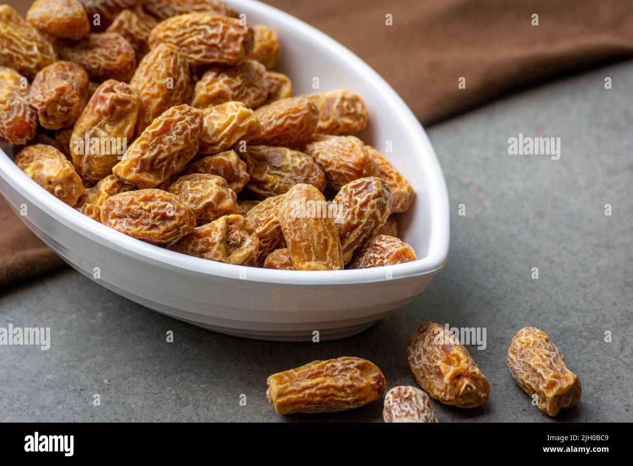 Indian dry dates in white bowl Stock Photo - Alamy