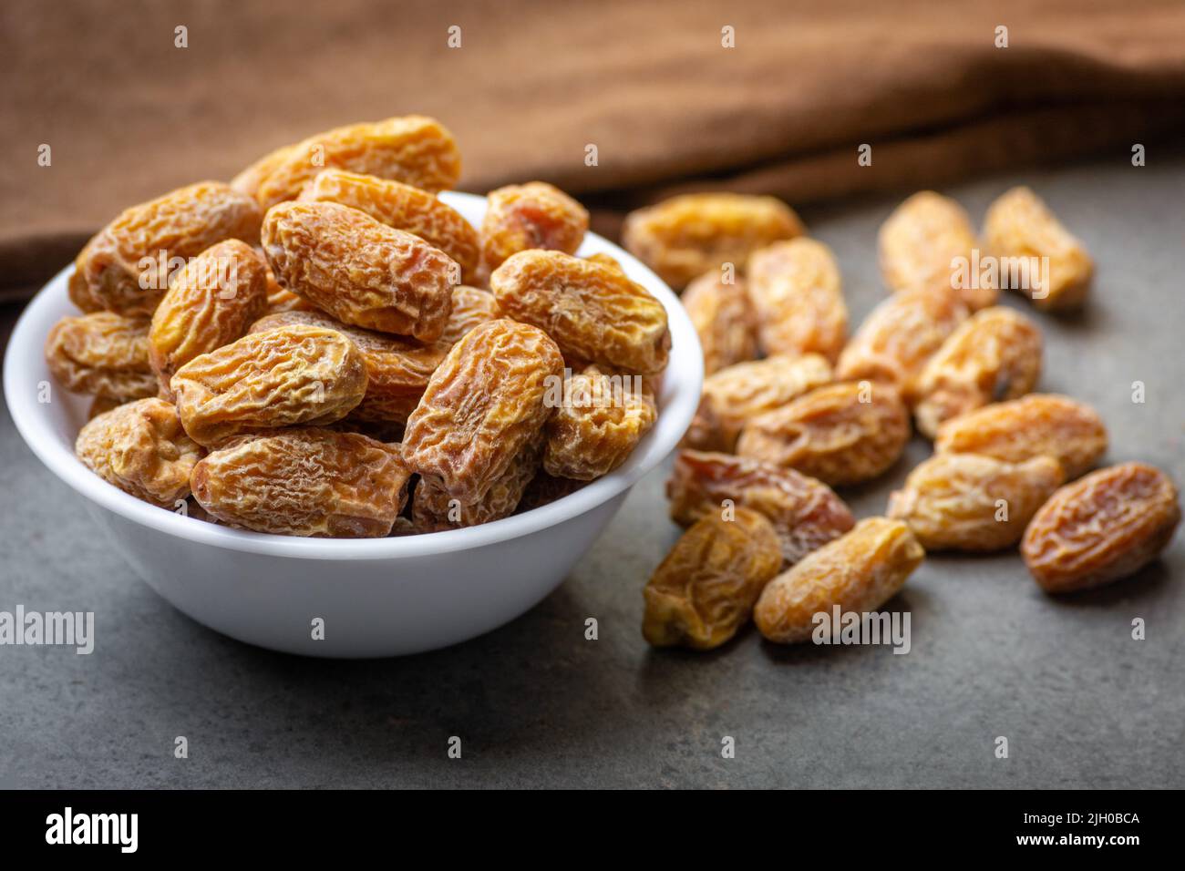 Indian dry dates in white bowl Stock Photo - Alamy