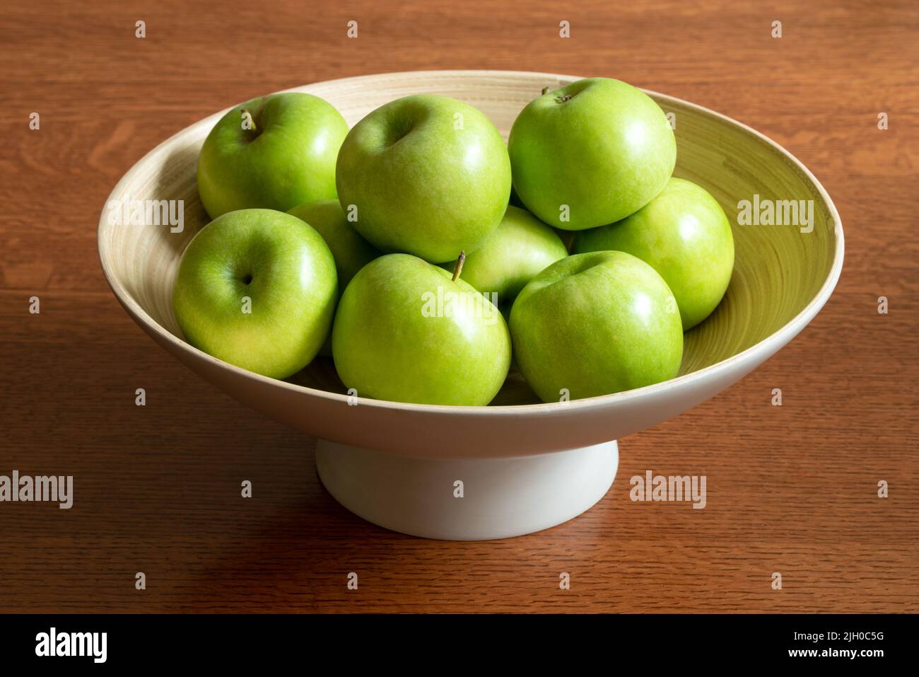 Green Apples in a Bamboo Bowl Stock Photo