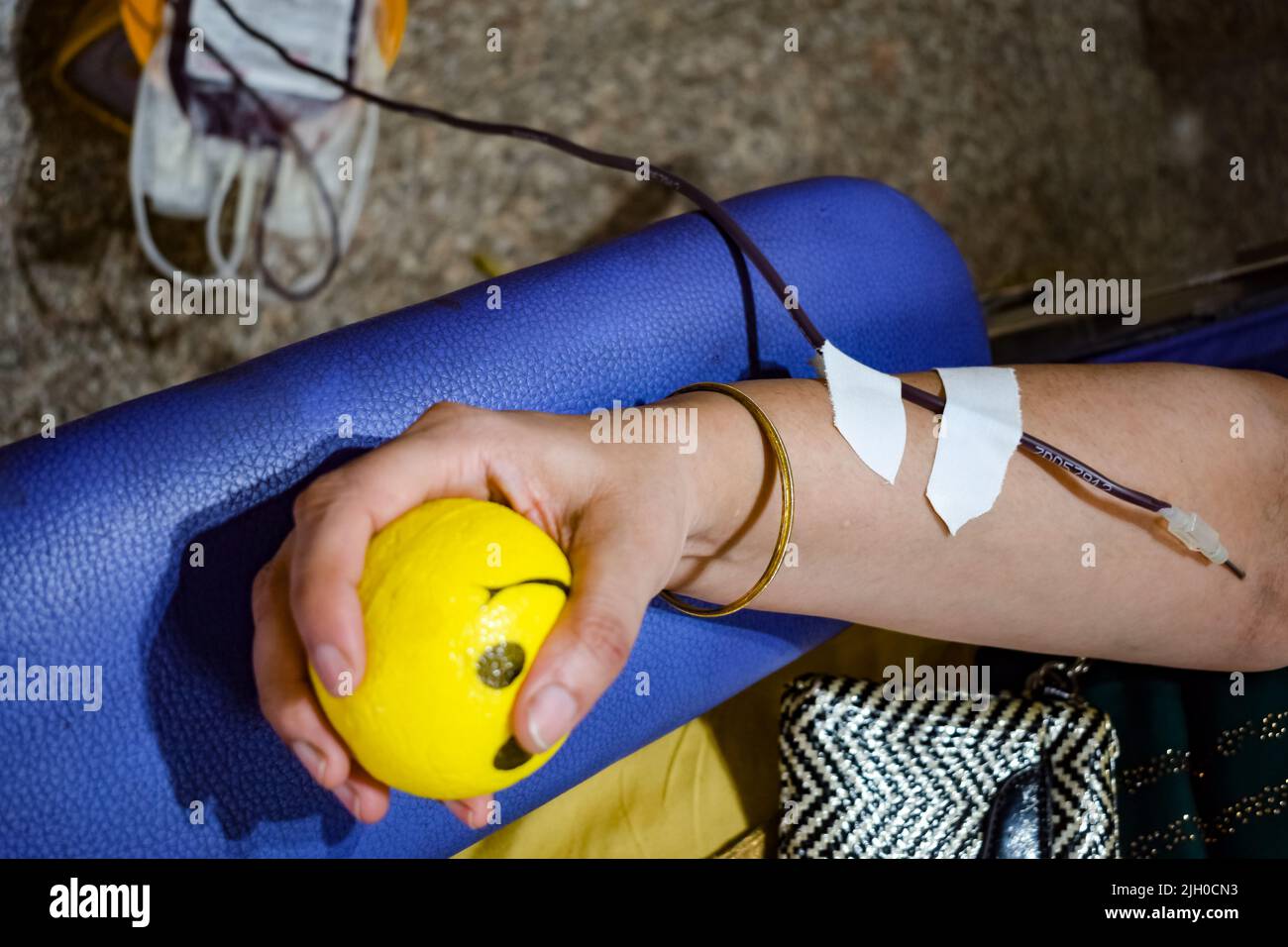 Blood donor at Blood donation camp held with a bouncy ball holding in hand at Balaji Temple, Vivek Vihar, Delhi, India, Image for World blood donor da Stock Photo