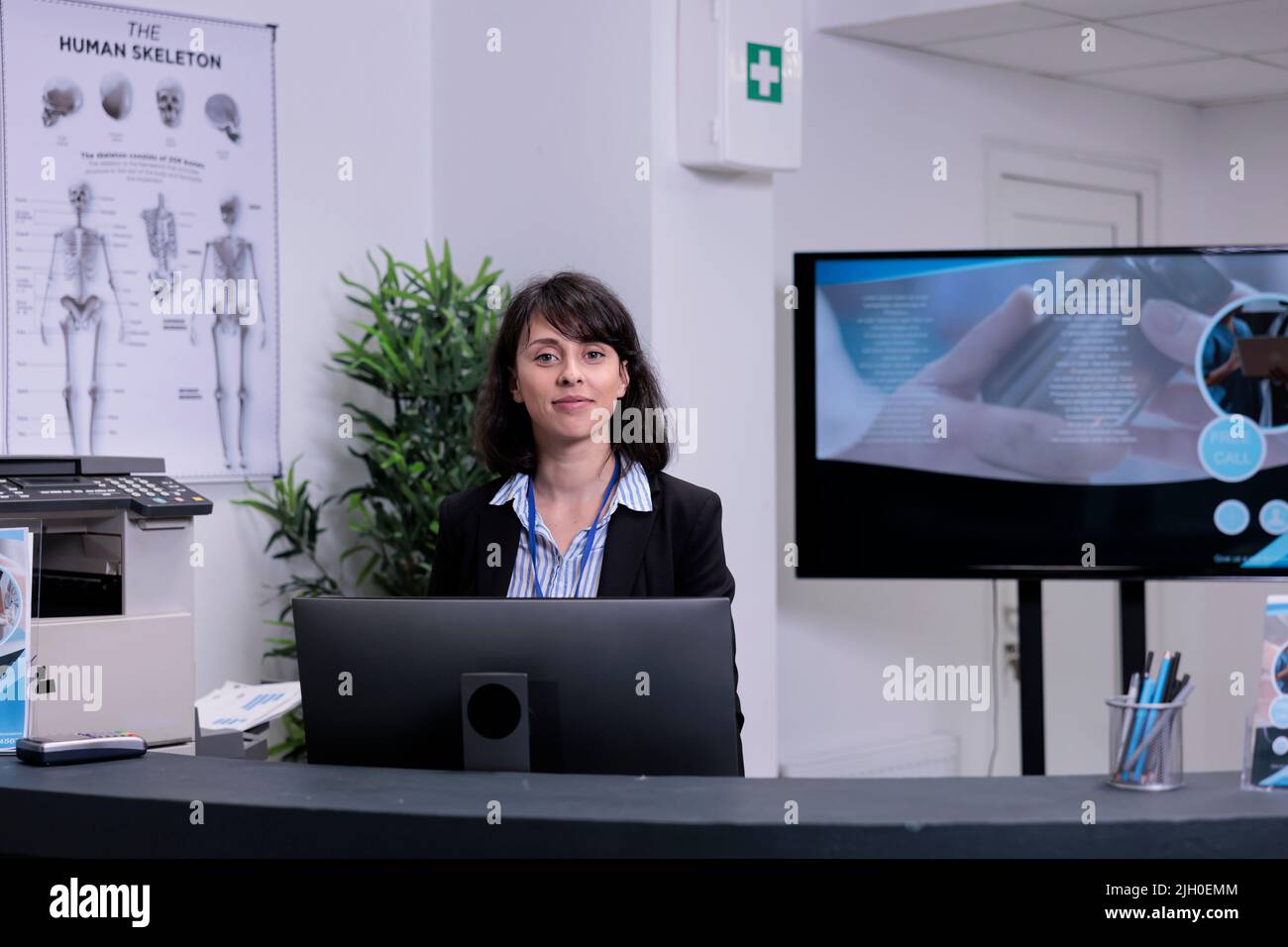 Portrait of smiling front desk receptionist waiting to greet patients
