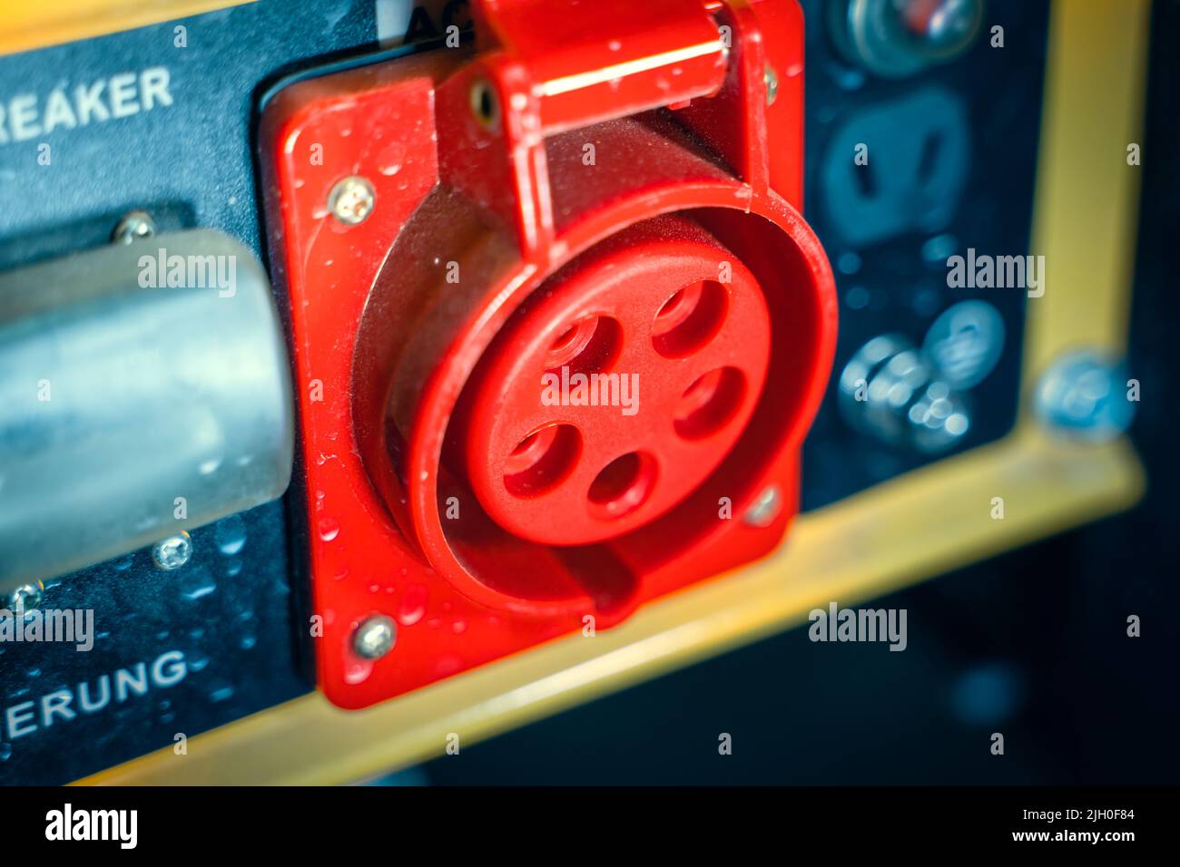 Power outlet with red grounding on the body of a gasoline electric