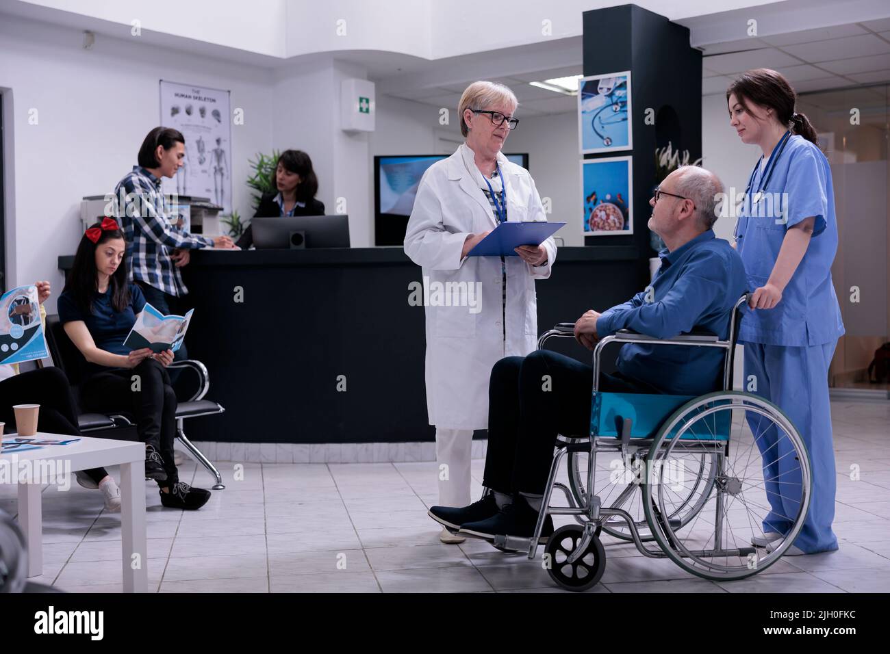 Retired person using wheelchair talking with senior doctor for appointment while being helped by