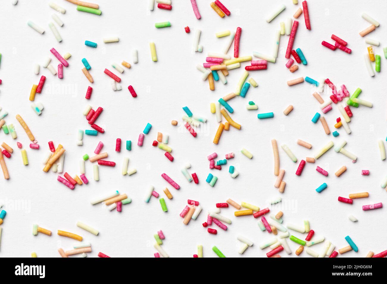 Candy multi colored sprinkles background. Rainbow coloured sprinkles on