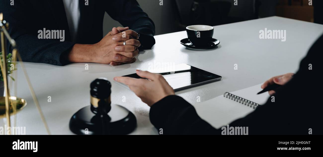 Businessman and Female lawyer or judge consult having team meeting with client, Law and Legal services concept. Stock Photo