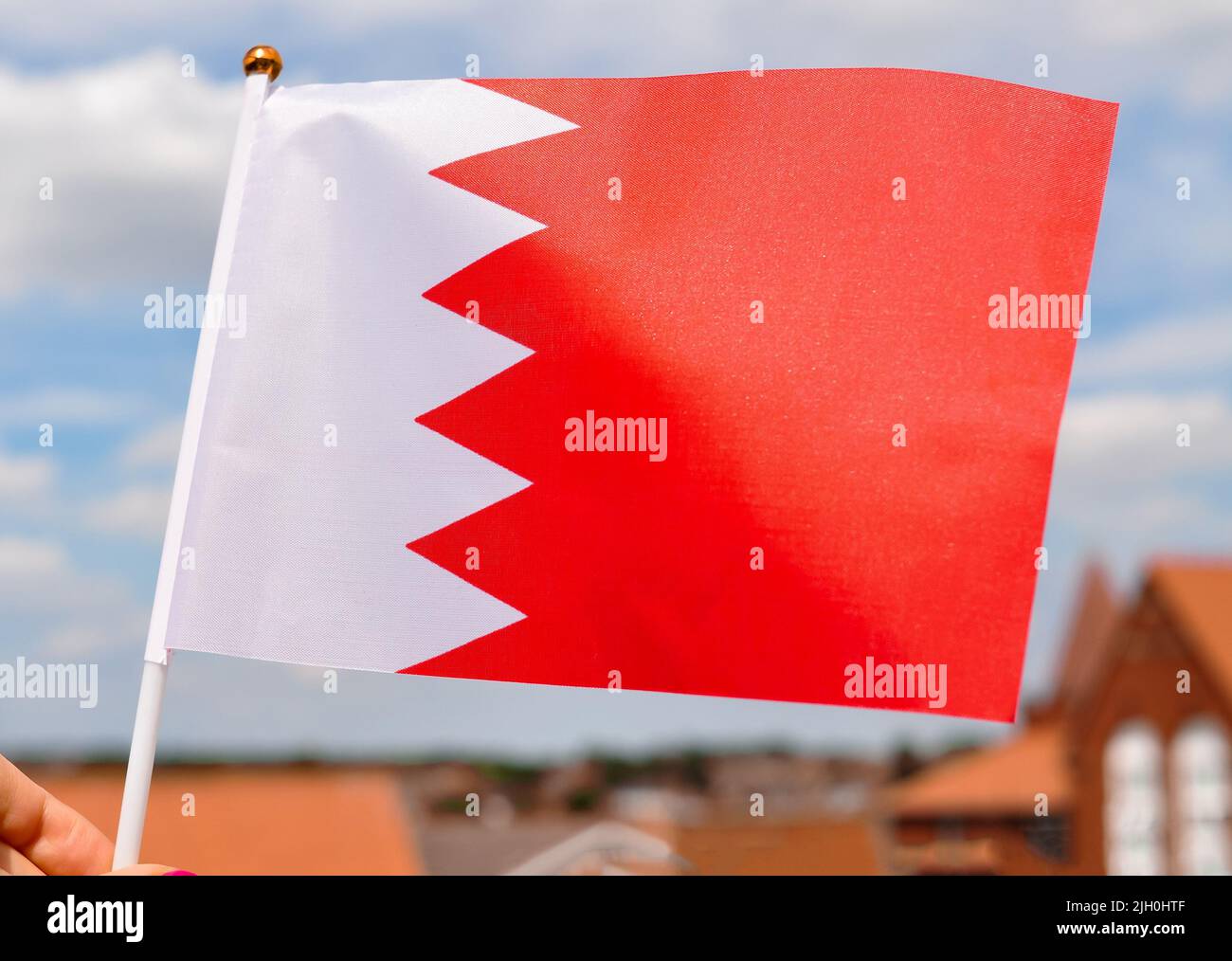 Close Up Of National Flag Of Bahrain On Blue Sky Background red And 
