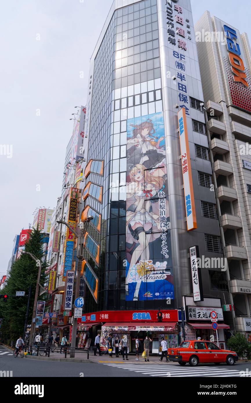 Akihabara, Japan- August 7, 2020: People walk through the town while a giant poster is hung in Akihabara. Stock Photo
