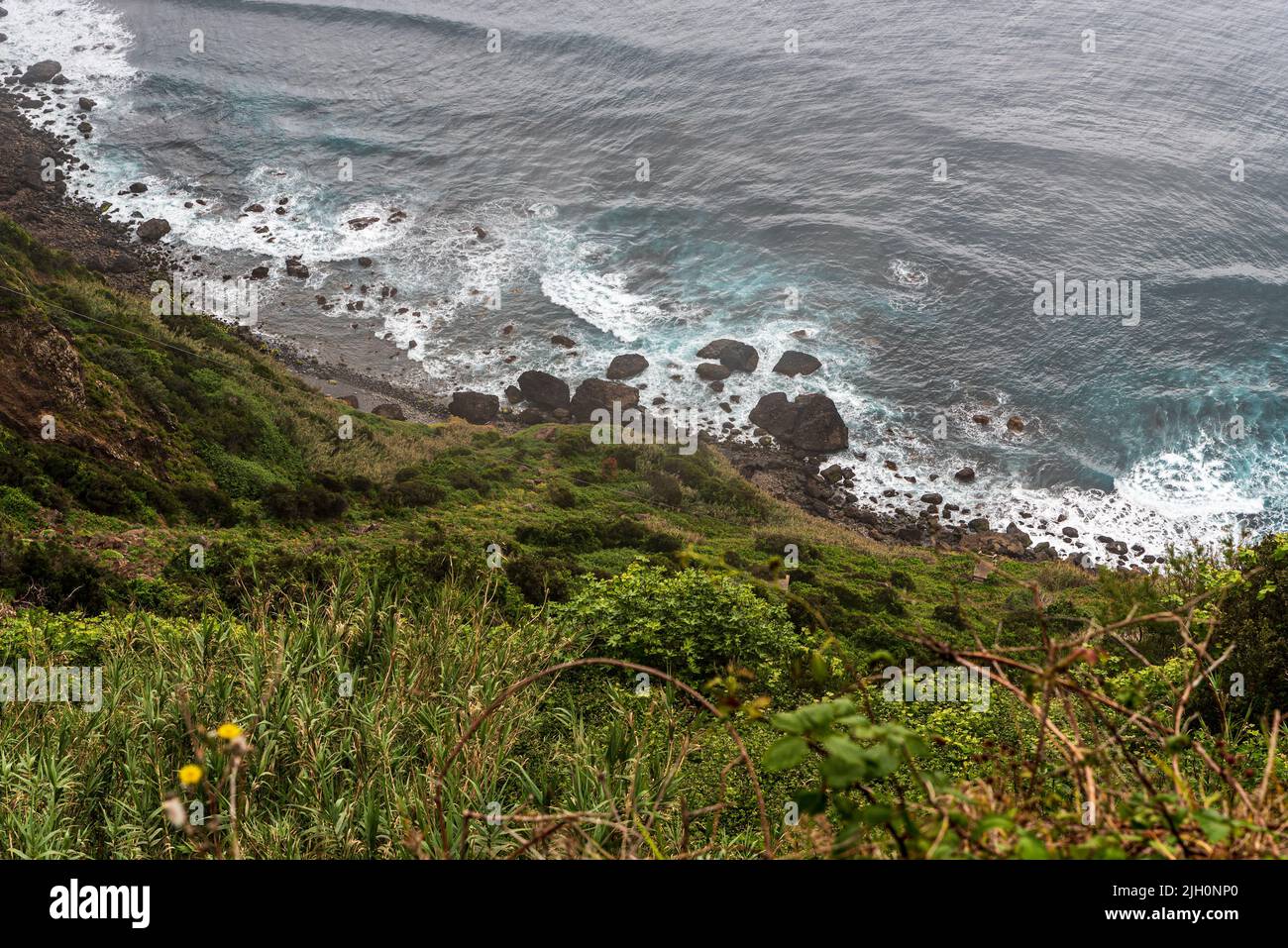 Wild Atlantic Ocean with small stone beach and wawes in Madeira - View from Vereda do Larano trail between Porto da Cruz and Canical Stock Photo