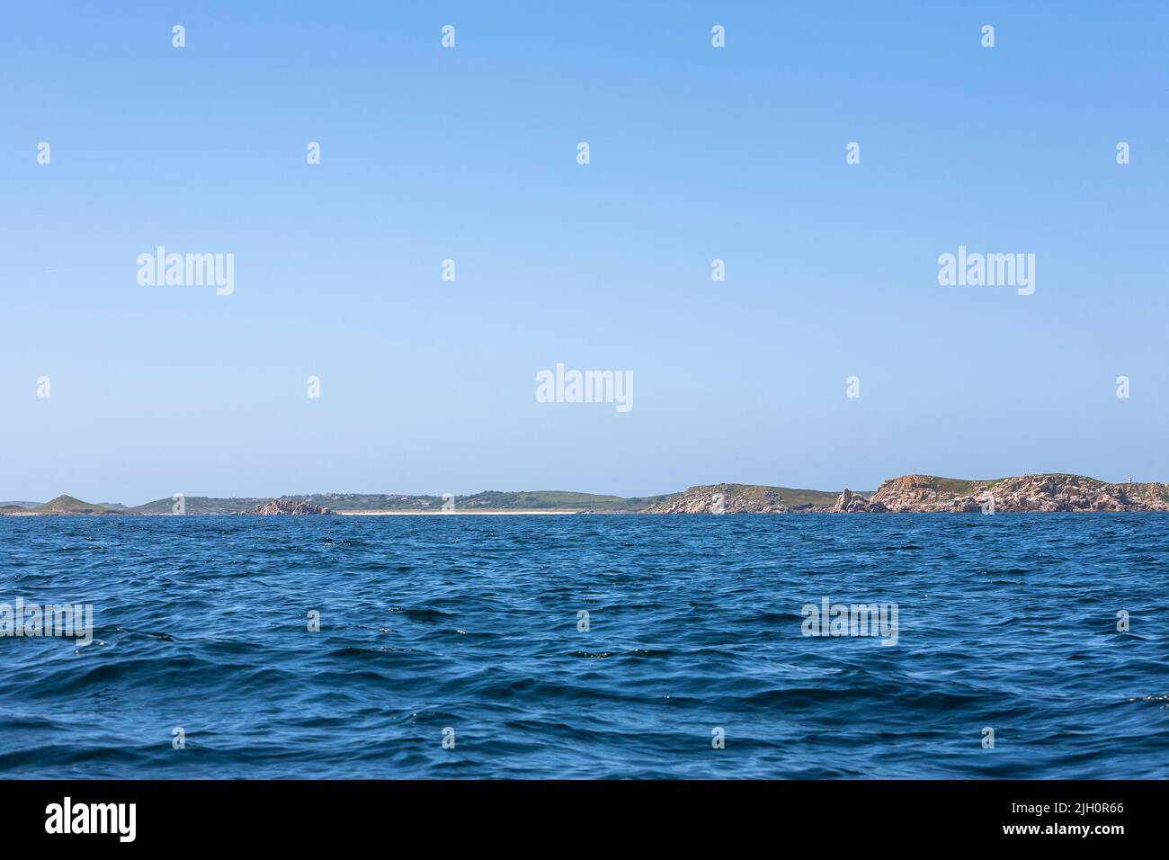 Approaching the Isles of Scilly by sea: the Eastern Isles and St. Martin's, with its distinctive Day Mark on the hilltop: Isles of Scilly, UK Stock Photo