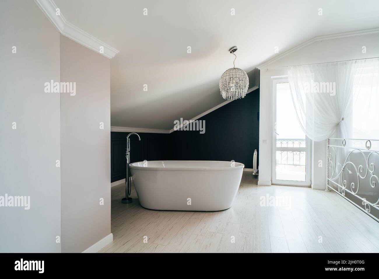 White bathroom in modern house stands in master bedroom. Stock Photo