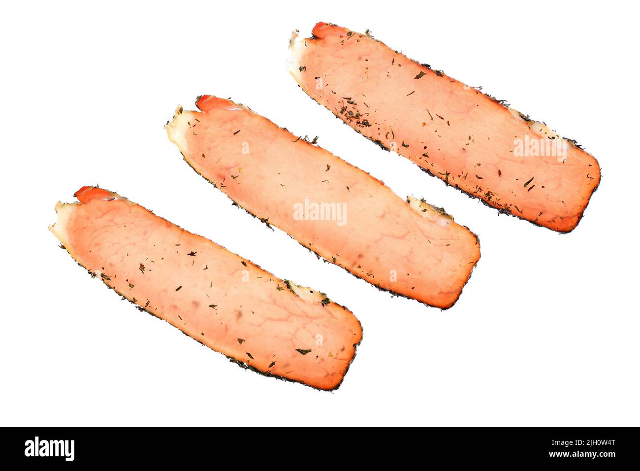 Three slices of Fillet Elena. Delicious, traditional Bulgarian dry cured pork loin with original spices, isolated on white background Stock Photo