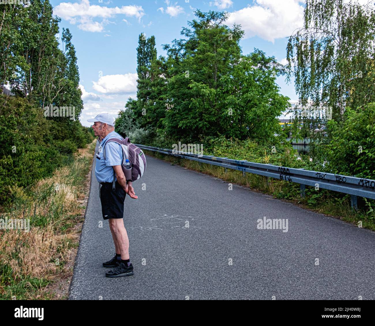 Senior elderly man walking the route of former Berlin wall along the Teltow Canal in Johannisthal, Treptow-Köpenick, berlin Stock Photo