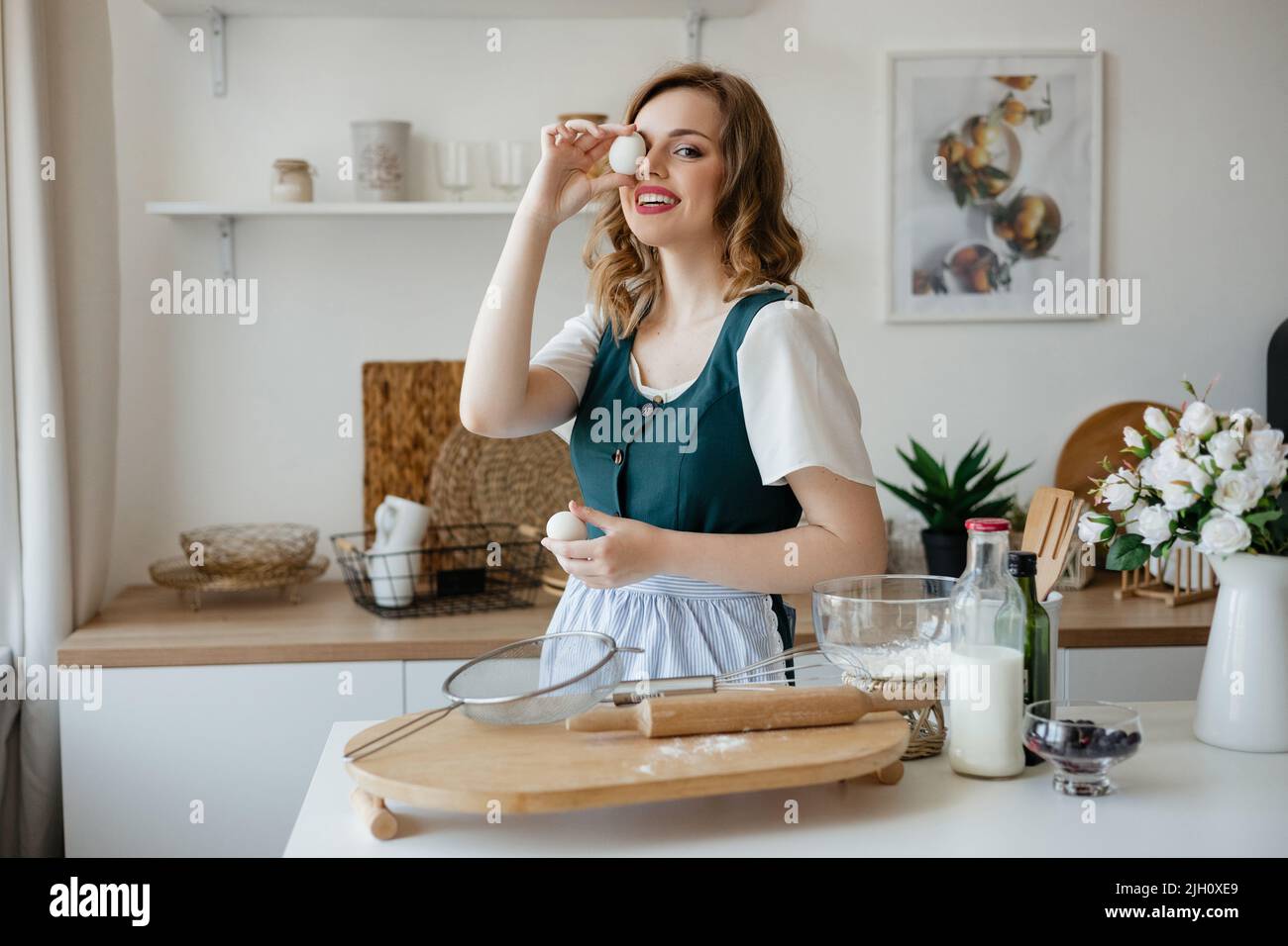 Girl confectioner holding chicken eggs in her hands Stock Photo