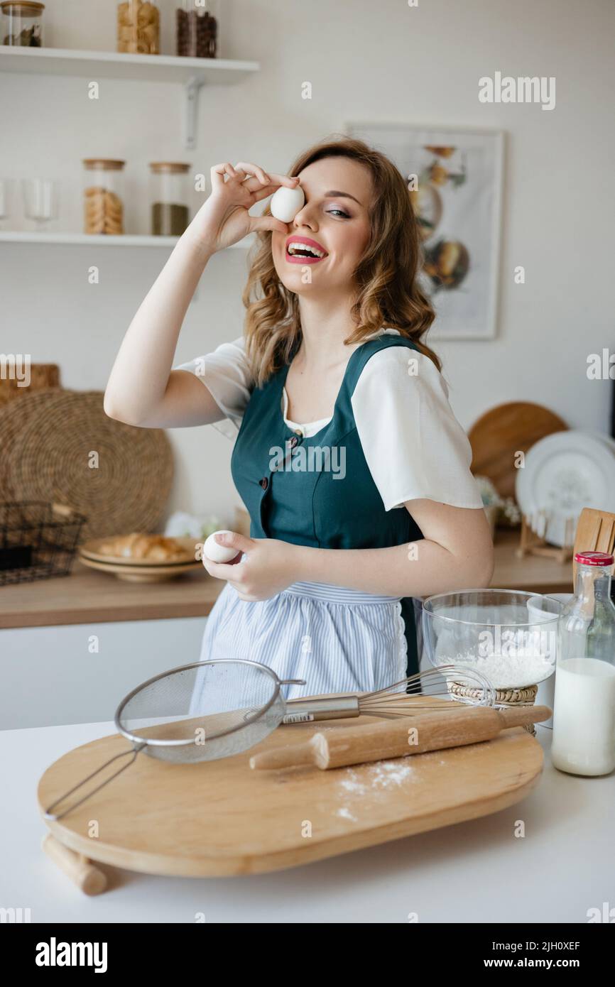 Girl confectioner holding chicken eggs in her hands Stock Photo
