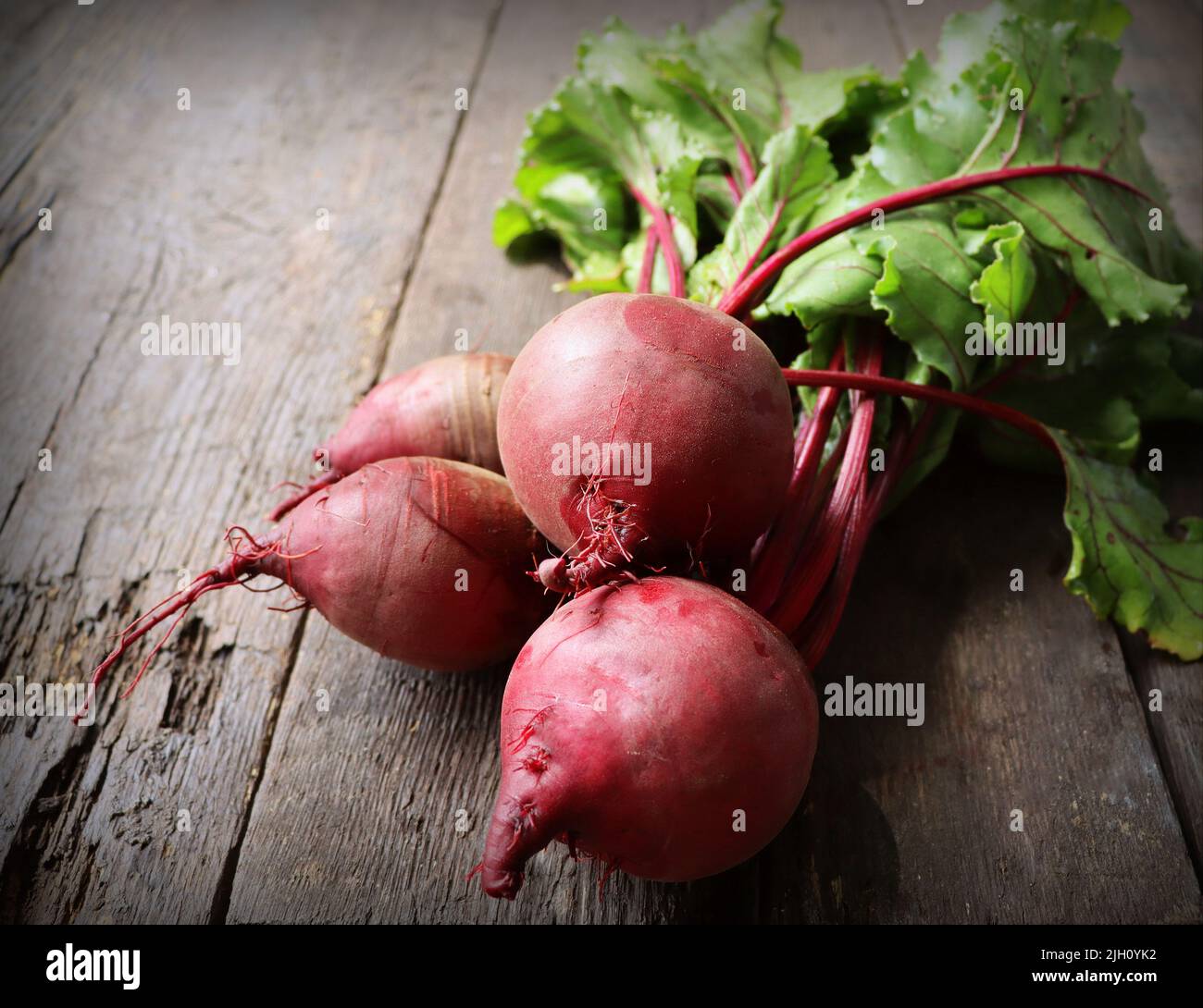 Fresh beetroot with leaves on a wooden background. Healthy food. Top view. Free space for your text Stock Photo