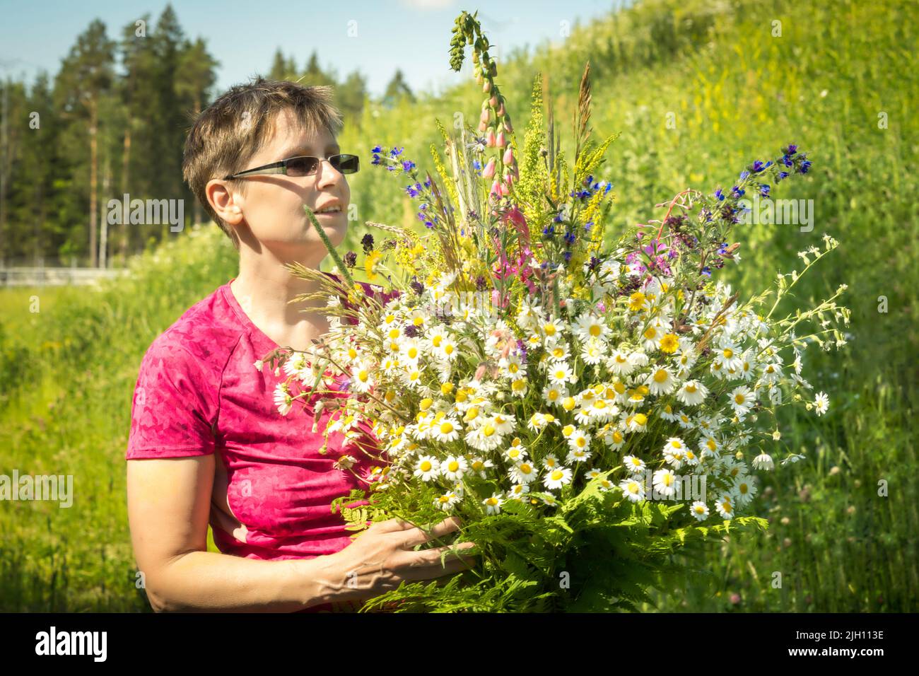portrait of a florist woman with bouquet of wild flowers Stock Photo