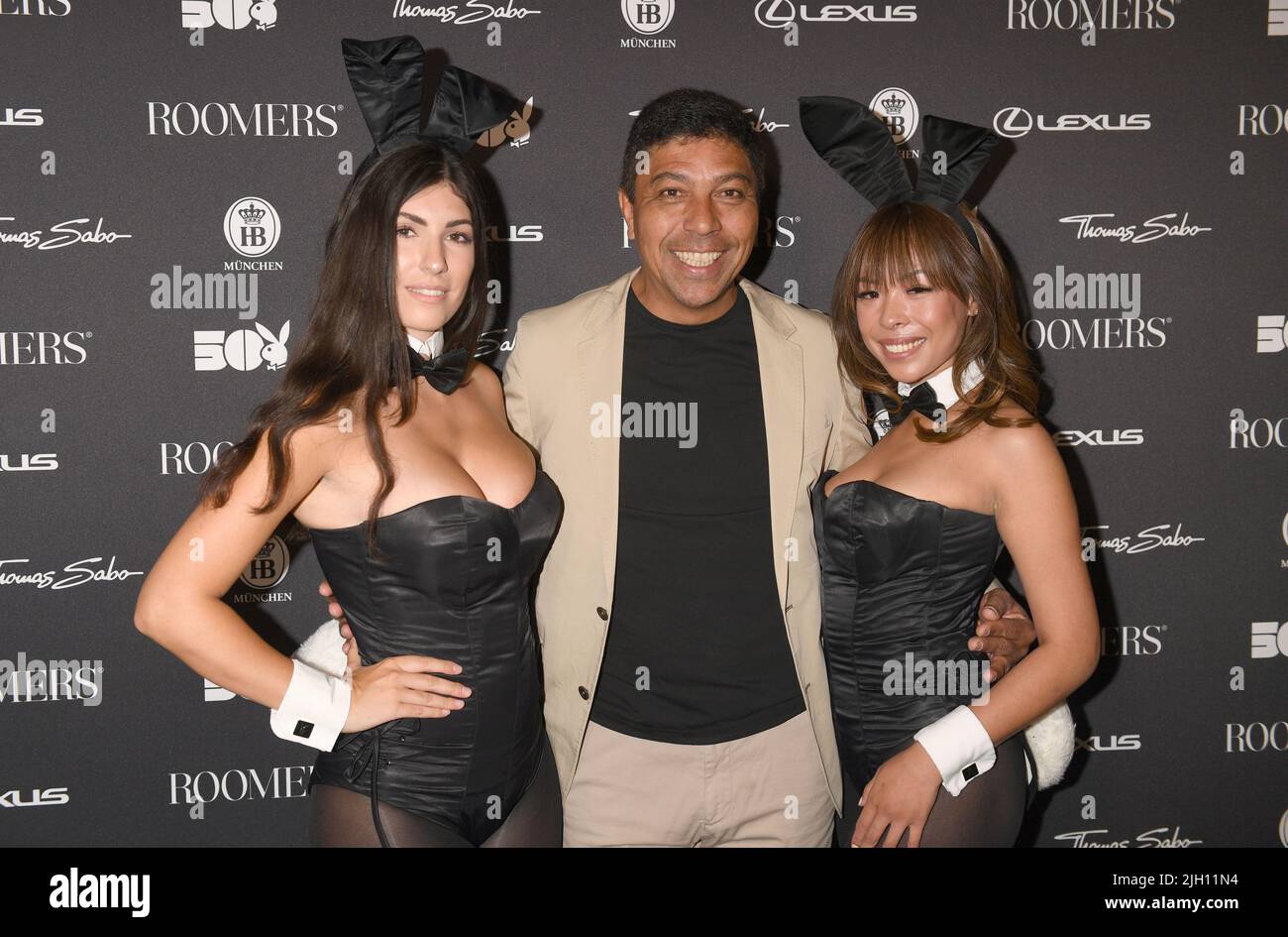 Munich, Germany. 13th July, 2022. Soccer player Giovane Élber shows off with Playboy bunnies at the '50 Years of Playboy Germany' anniversary party in the penthouse at Plant 12. Around 300 guests are expected at the anniversary celebration. Credit: Felix Hörhager/dpa/Alamy Live News Stock Photo