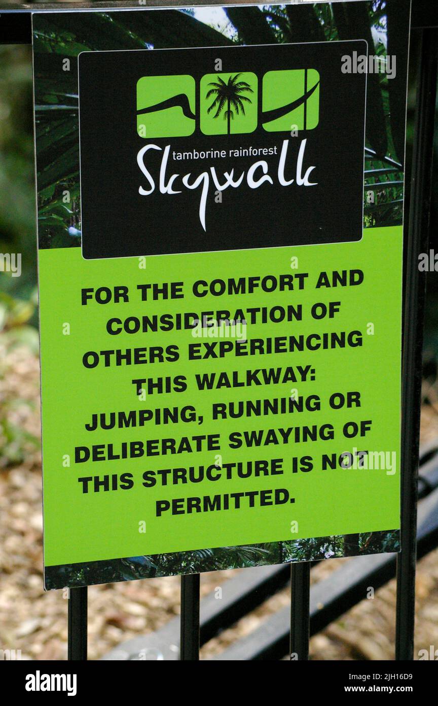 Skywalk elevated treetop walk through rainforest on Tamborine Mountain, Queensland,  Australia. Notice with advice for visitors. Stock Photo