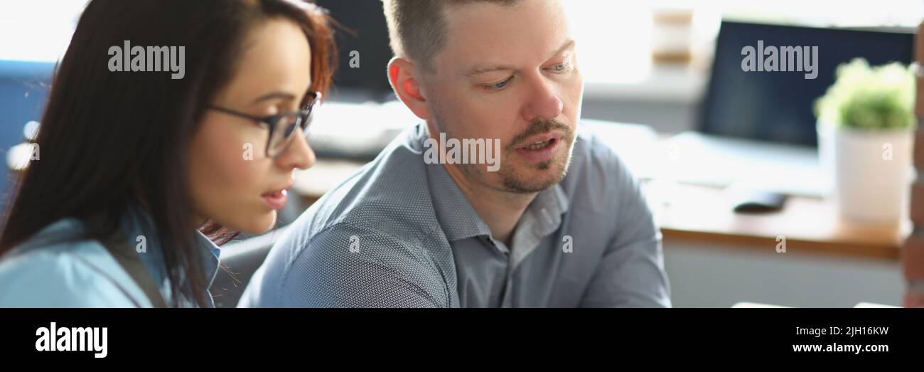 Smart man colleague help coworker with working process, explain