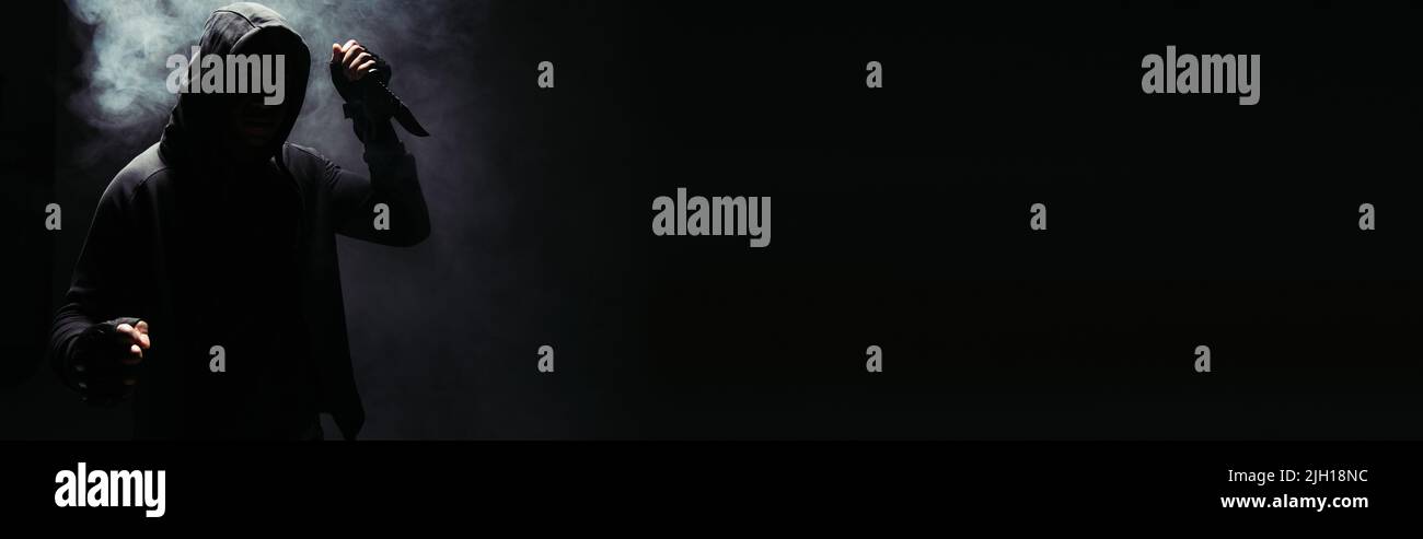 Silhouette of african american hooligan holding knife on black ...