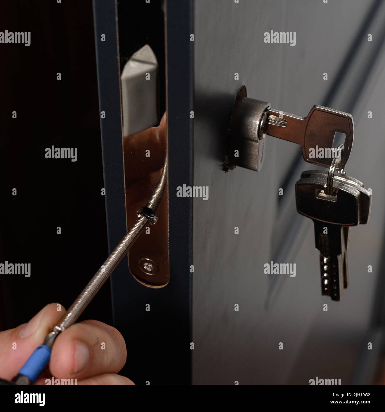 Installation of lock and door handle to interior doors, locksmith works with doors Stock Photo