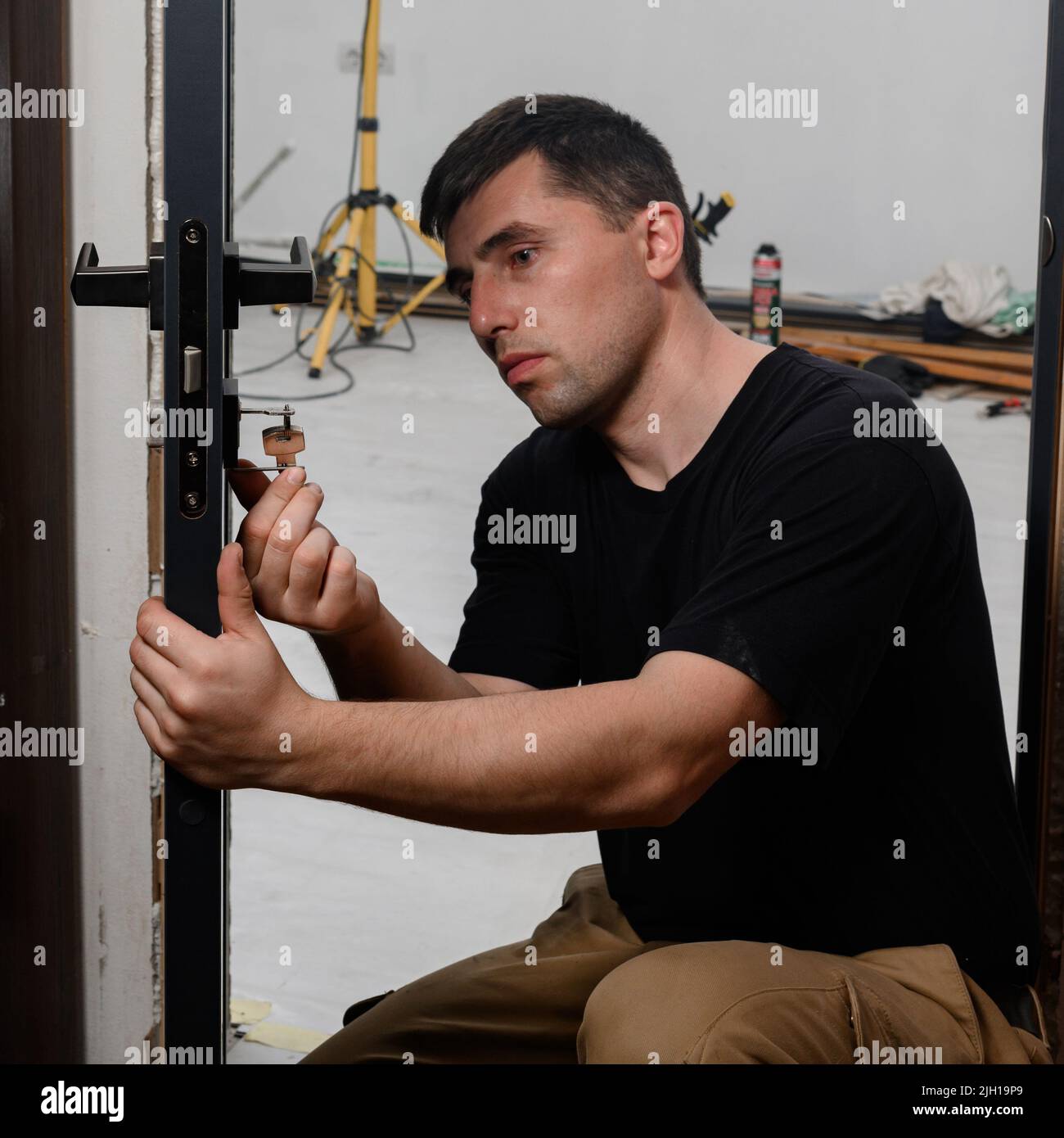 The technique of installing a door lock in an interior door Stock Photo ...