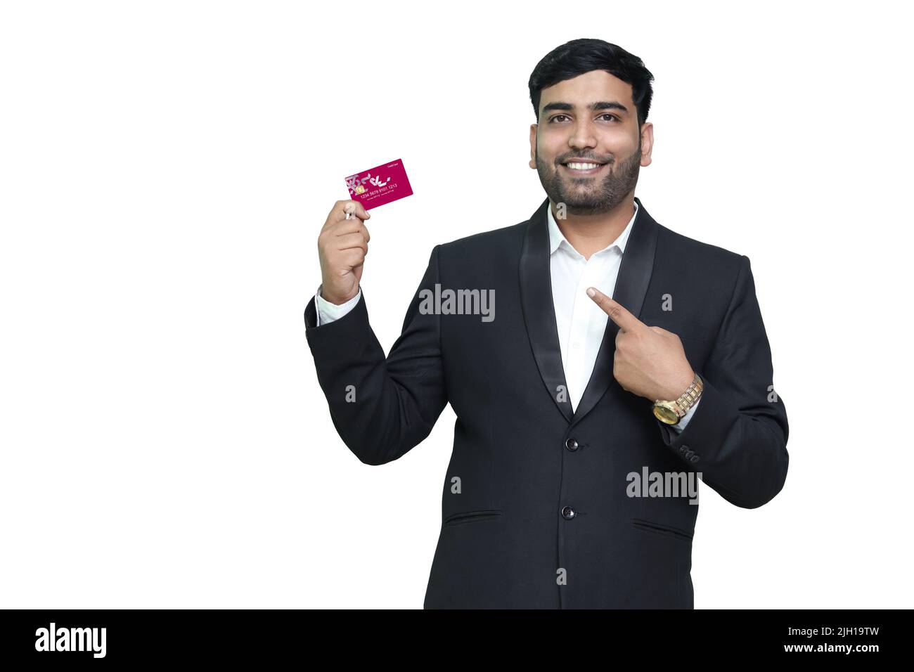 Young smiling man in pointing on credit card. Stock Photo