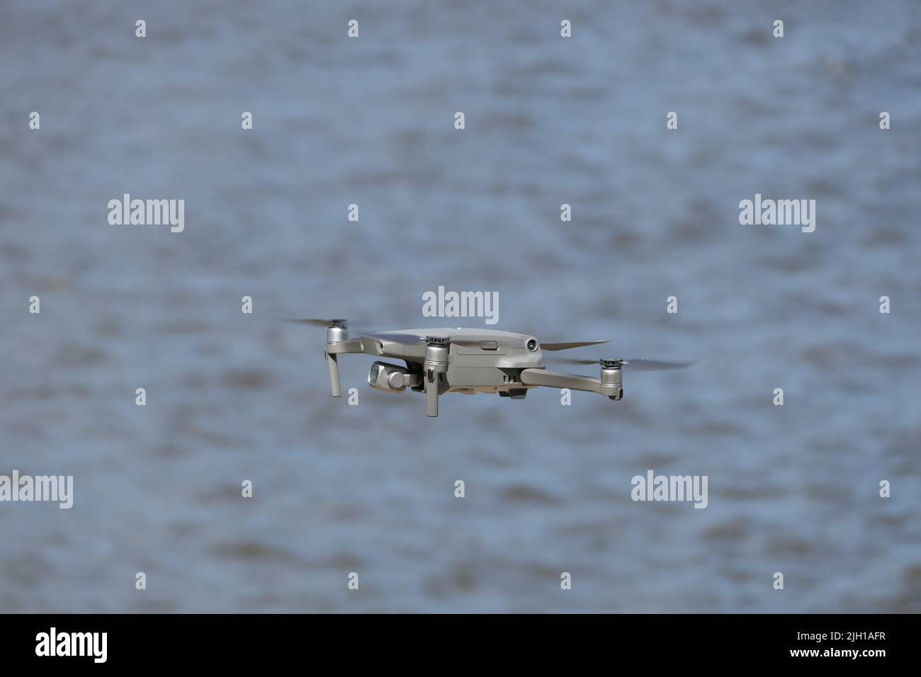 Gray quadcopter in flight. Photo-video aerial photography Stock Photo ...