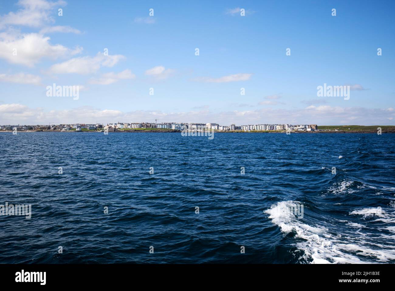 portrush viewed from at sea off the north coast of northern ireland on a summers morning Stock Photo
