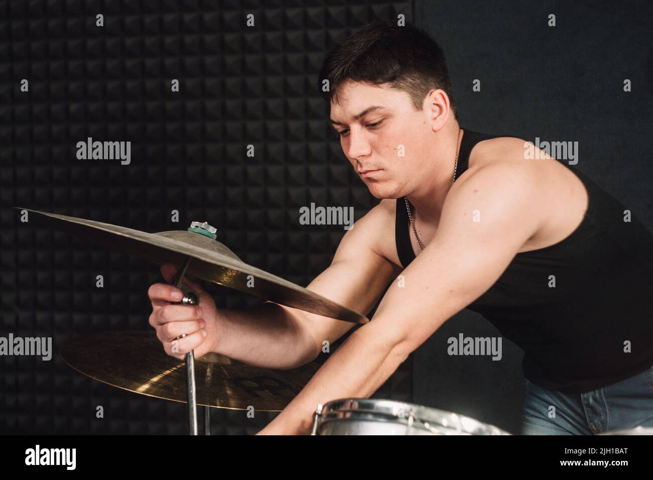 Drum player tuning his drums close-up Stock Photo