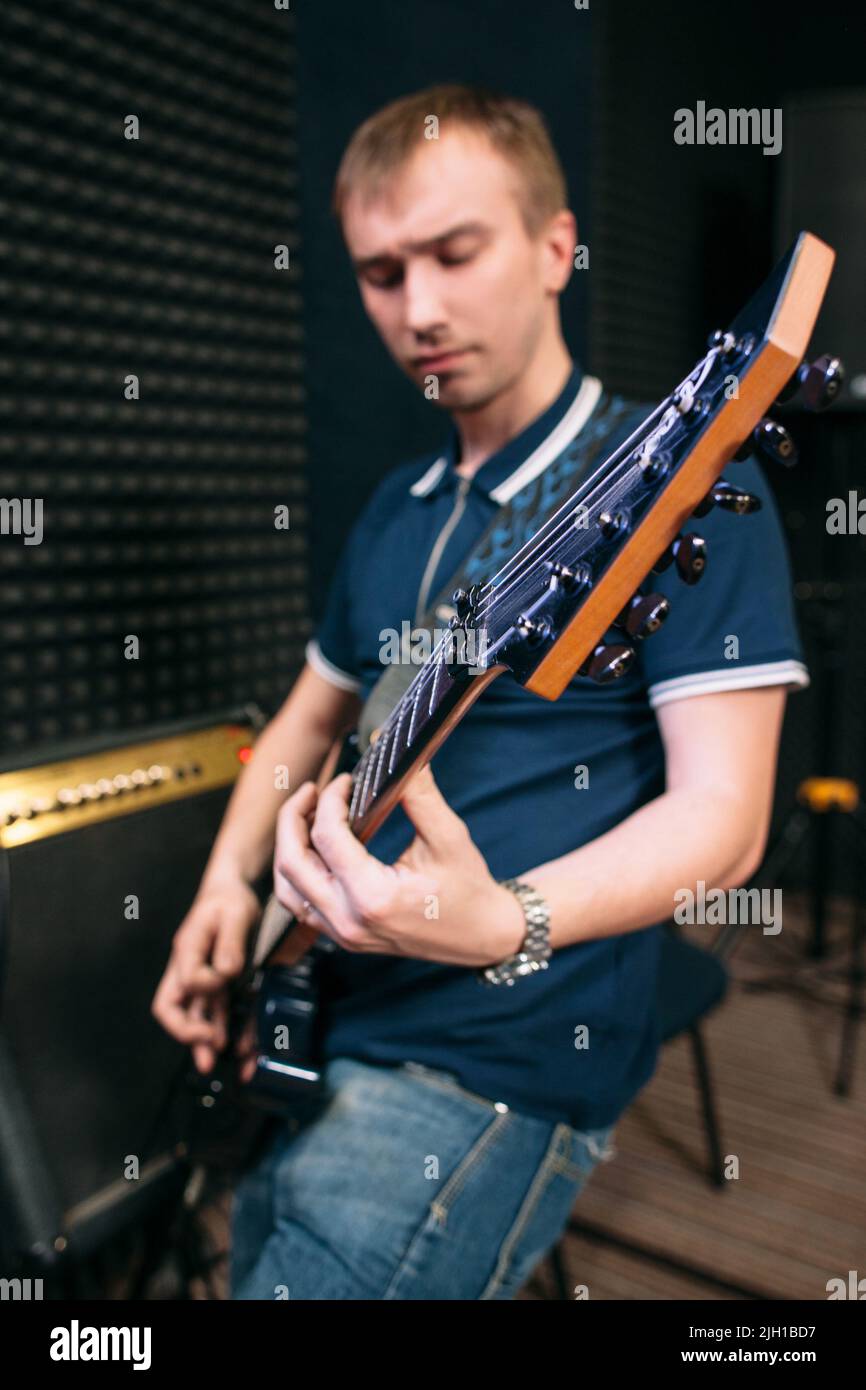 Bass guitar player playing music, close-up Stock Photo