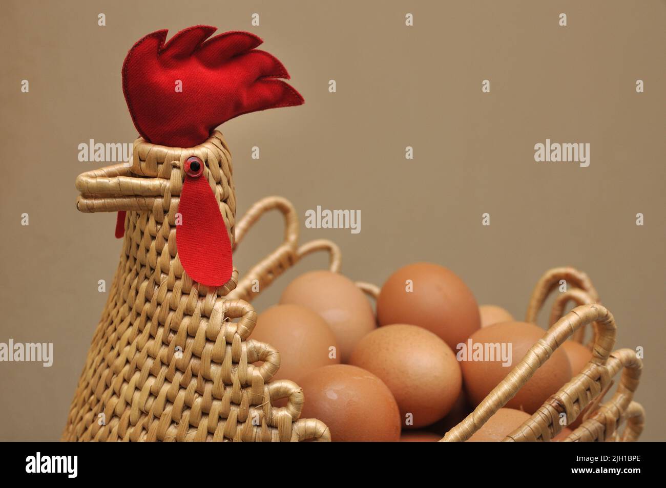 Chicken and egg, Eggs in a chicken shape basket Stock Photo