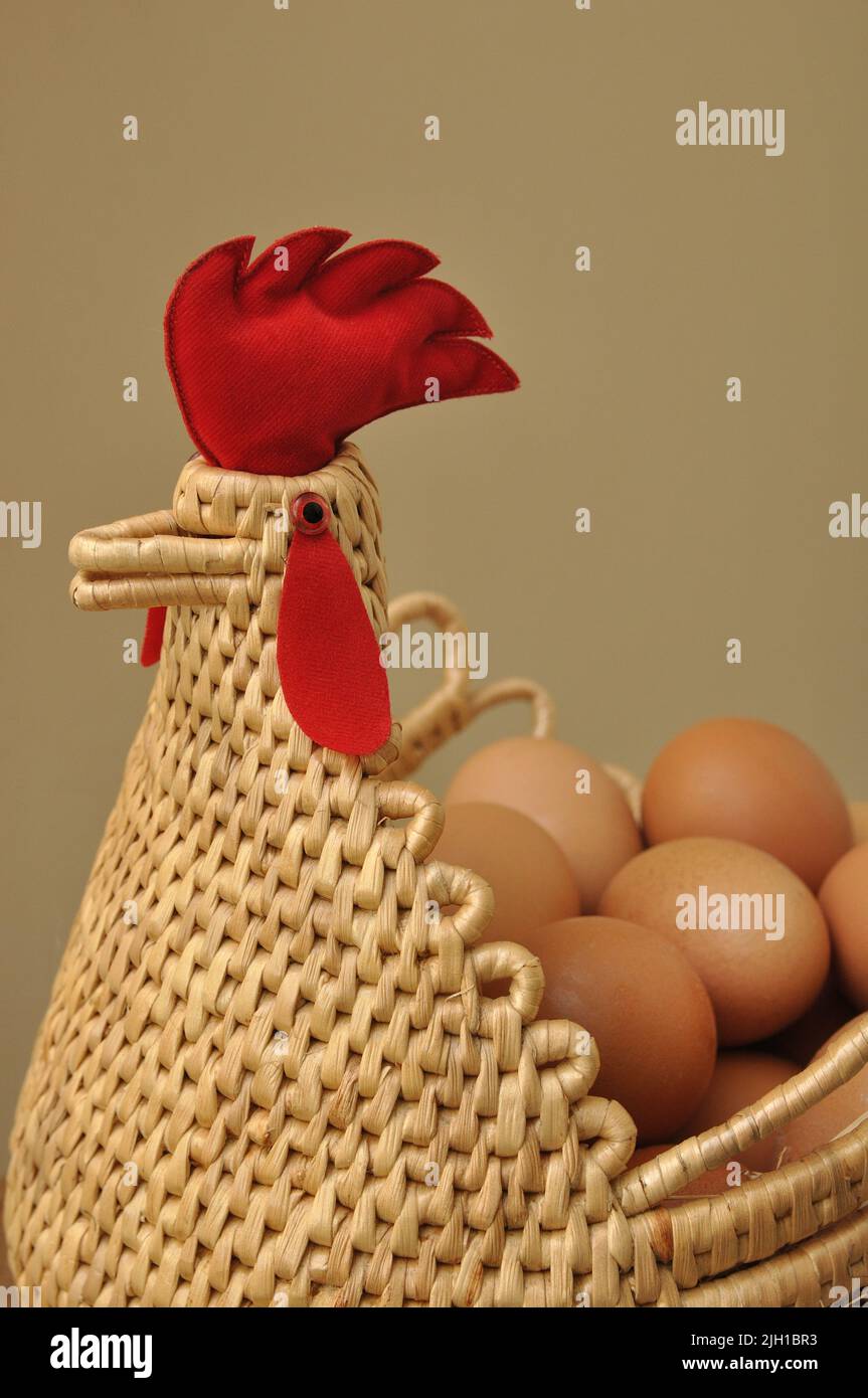 Chicken and egg, Eggs in a chicken shape basket Stock Photo
