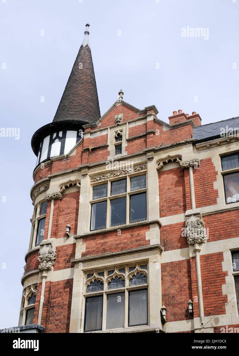 An elegant, red brick building with a turreted roof at the edge of Lincoln city centre, uk. Stock Photo
