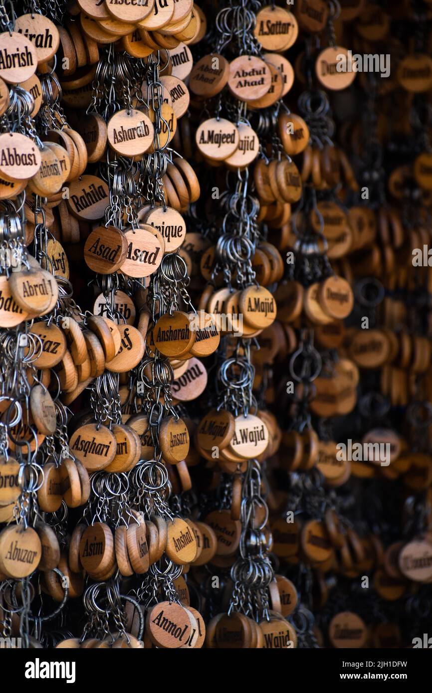 A vertical shot of hanging circle souvenirs with names Stock Photo Alamy
