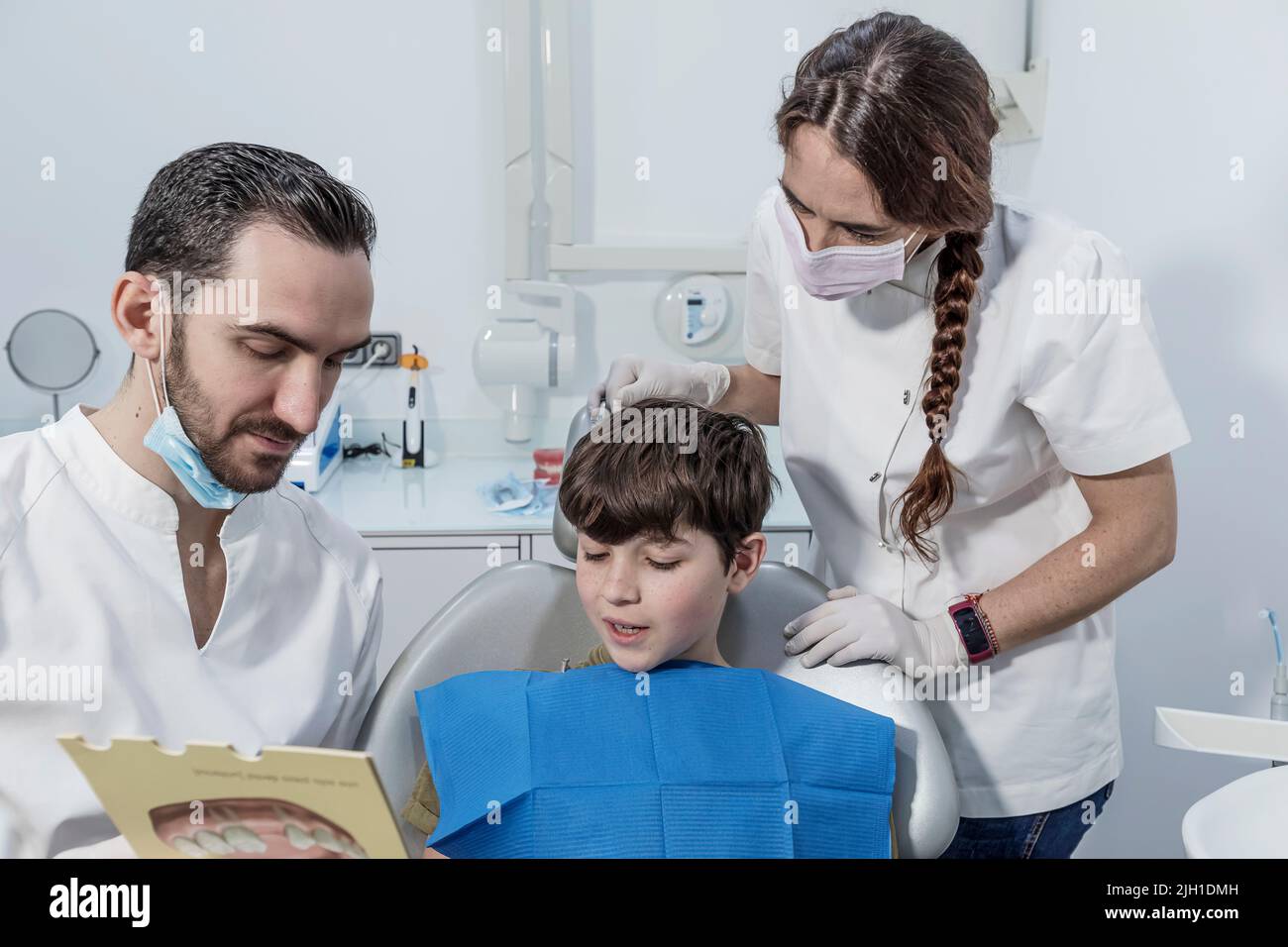 Orthodontic treatment. the dentist shows the boy an example of