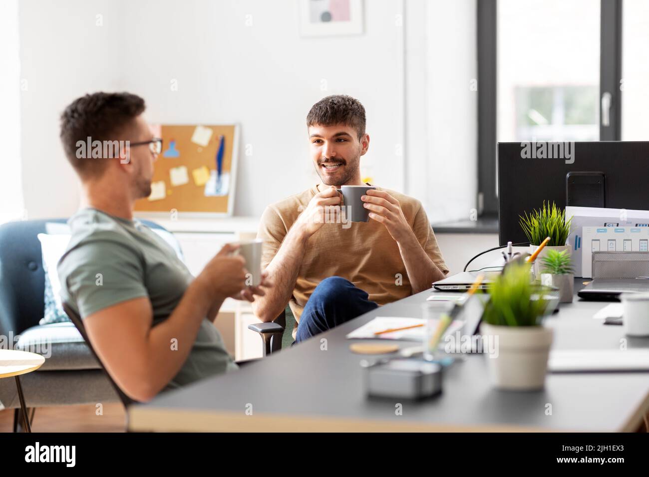 men or startuppers drinking coffee at office Stock Photo