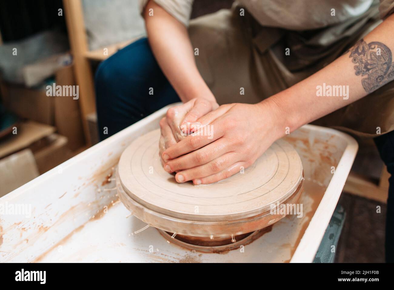 Potter working on potters wheel closeup. Start of making pottery