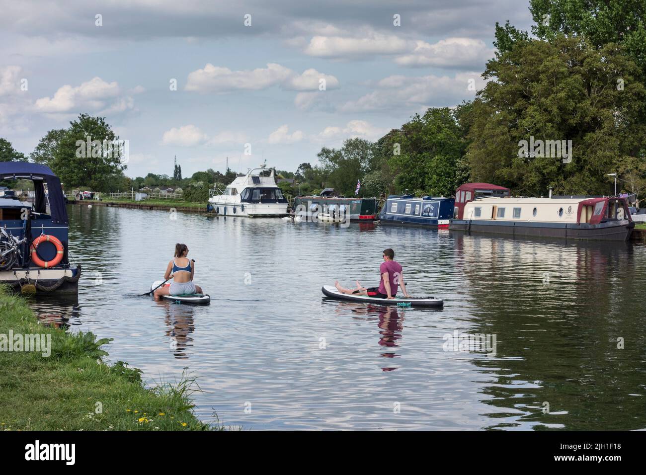 Young couple on water boards, Gloucester and Sharpness Canal, Frampton on Severn, Gloucestershire, UK Stock Photo