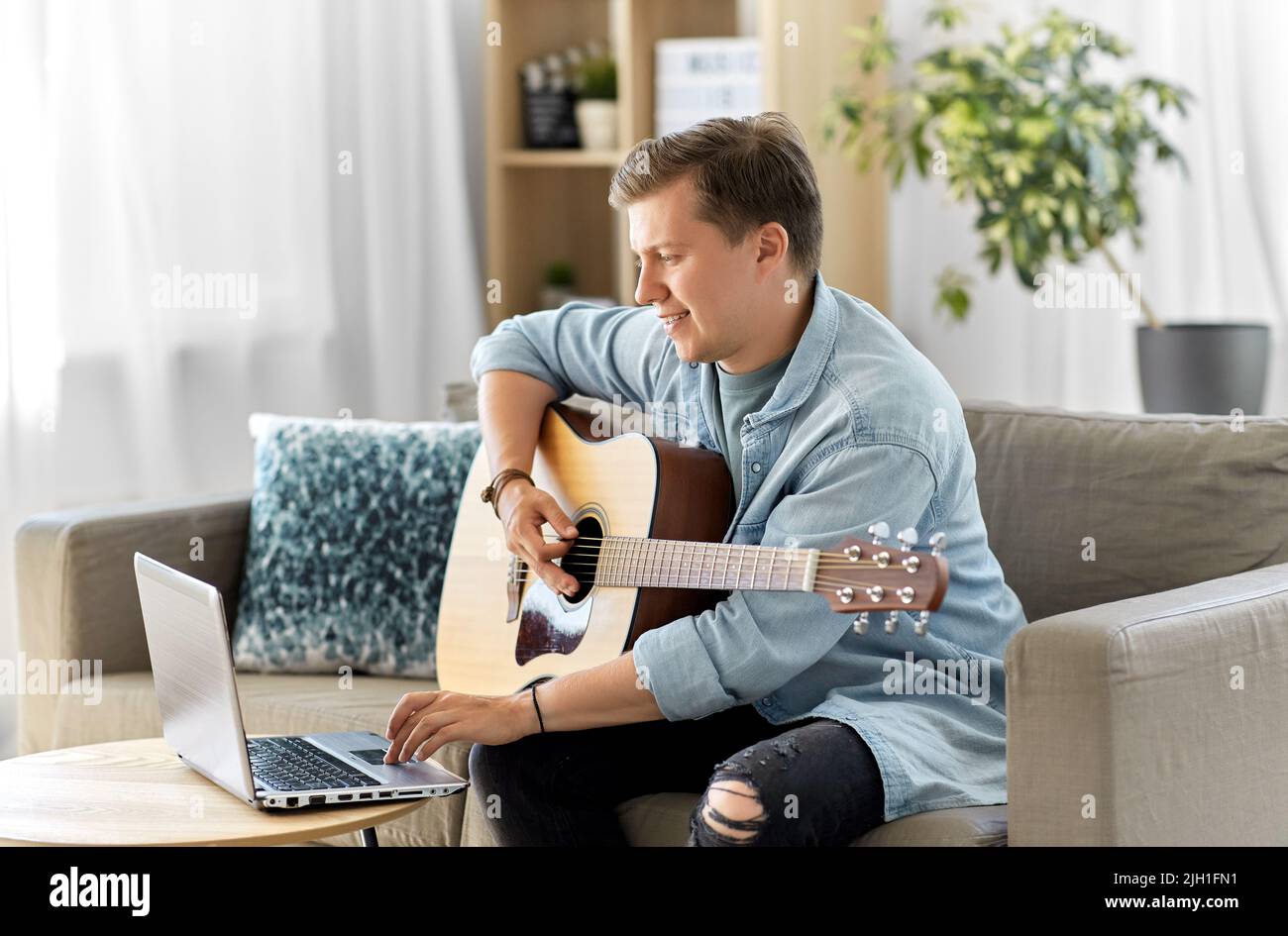 Young guy playing guitar home hi-res stock photography and images - Alamy