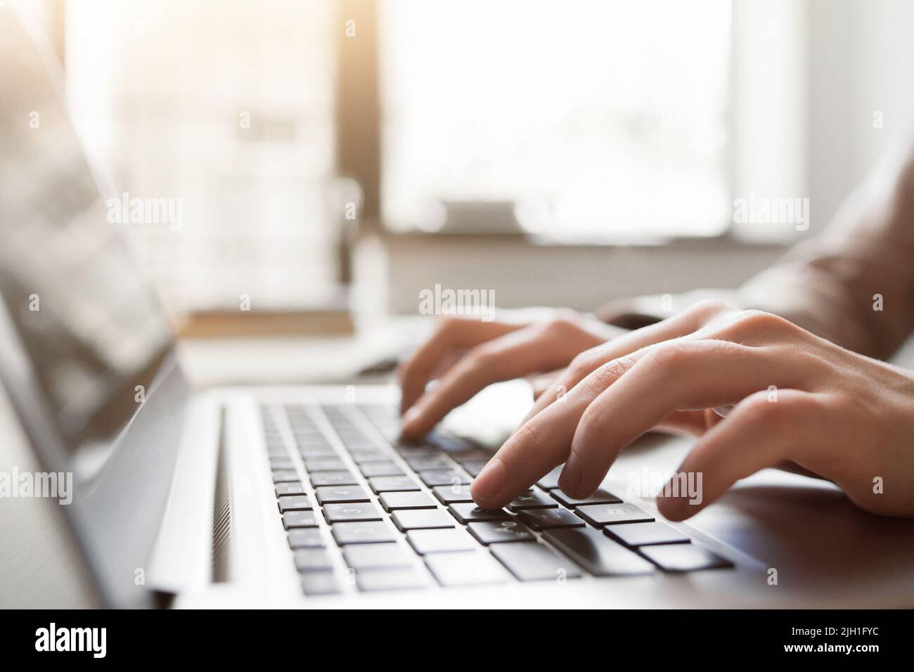 Typing on laptop closeup, chatting in Facebook, meeting website. Blogger, journalist writing new article. Stock Photo