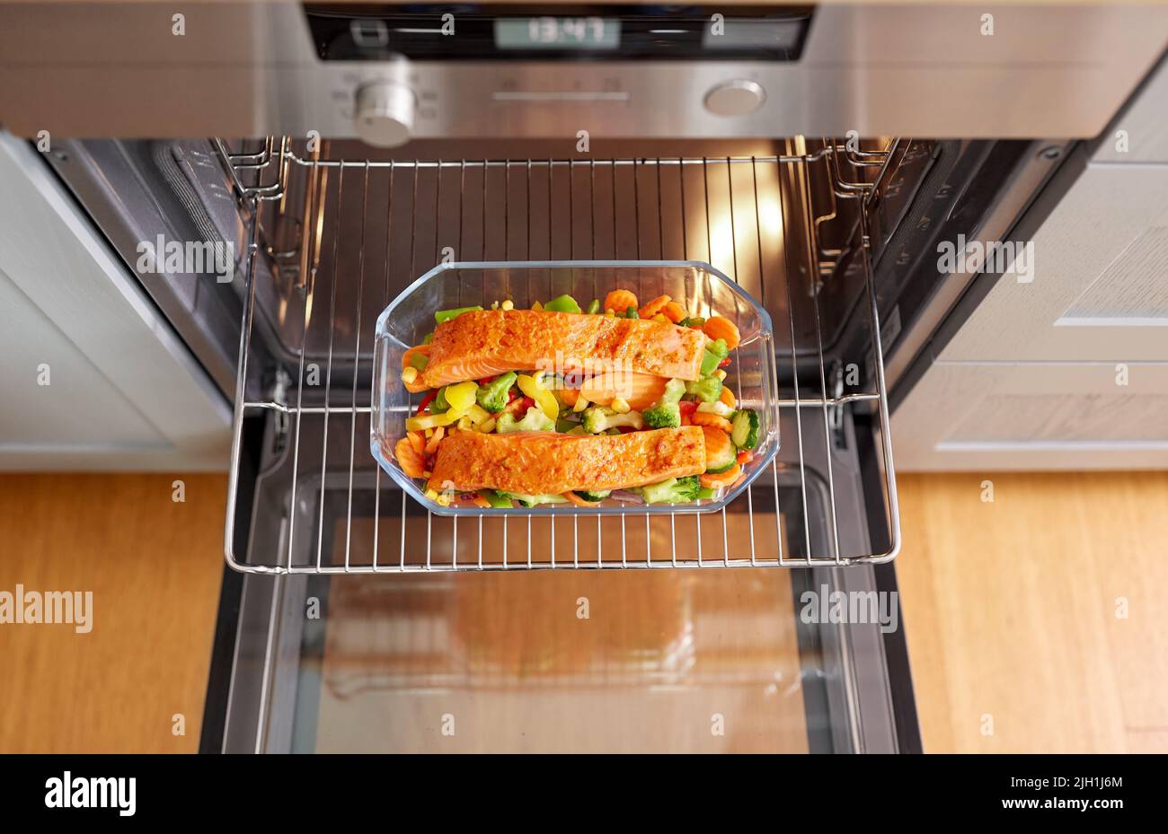 food cooking in baking dish in oven at home Stock Photo Alamy